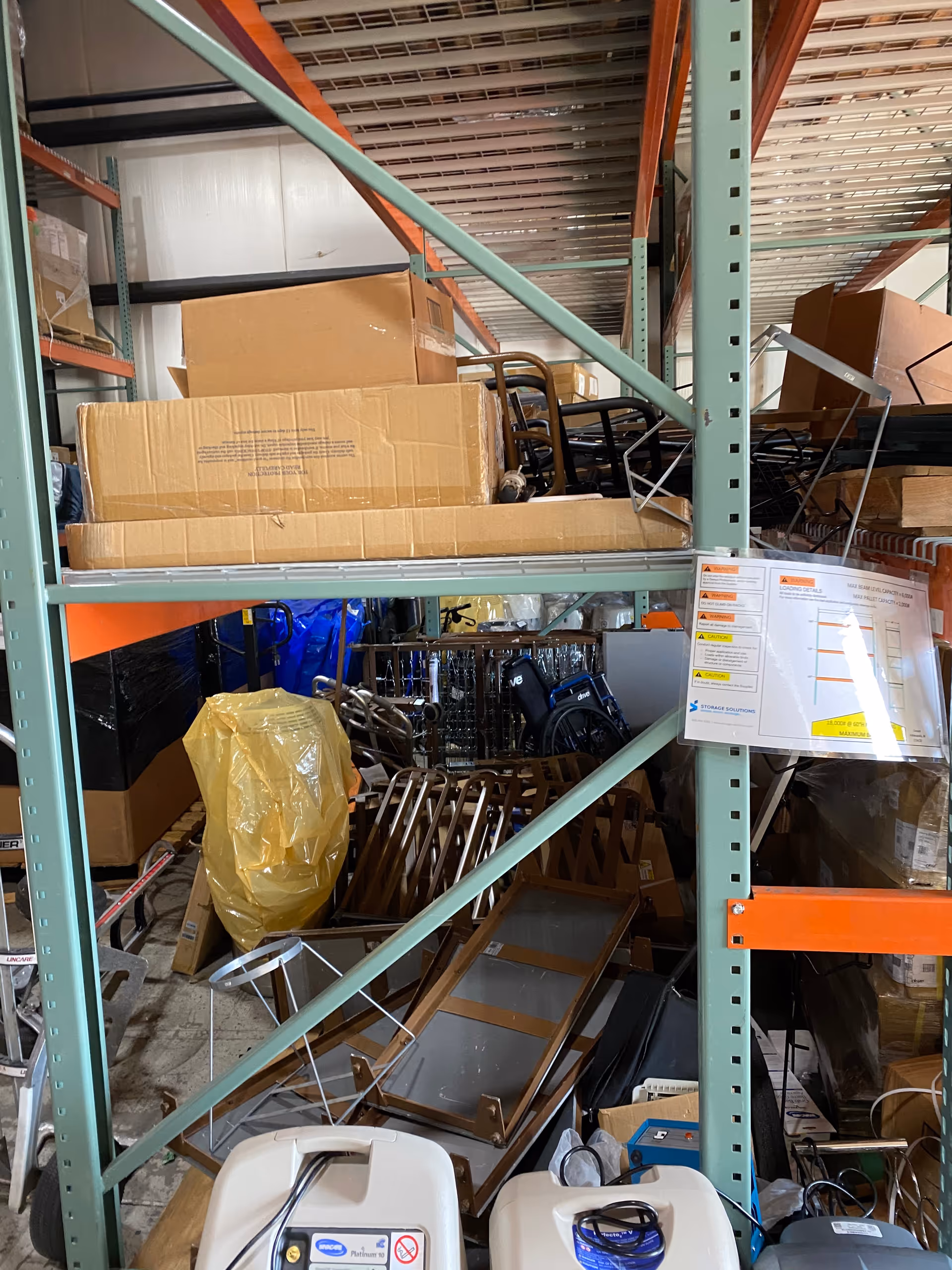Interior storage area with metal shelves, cardboard boxes, and miscellaneous equipment.