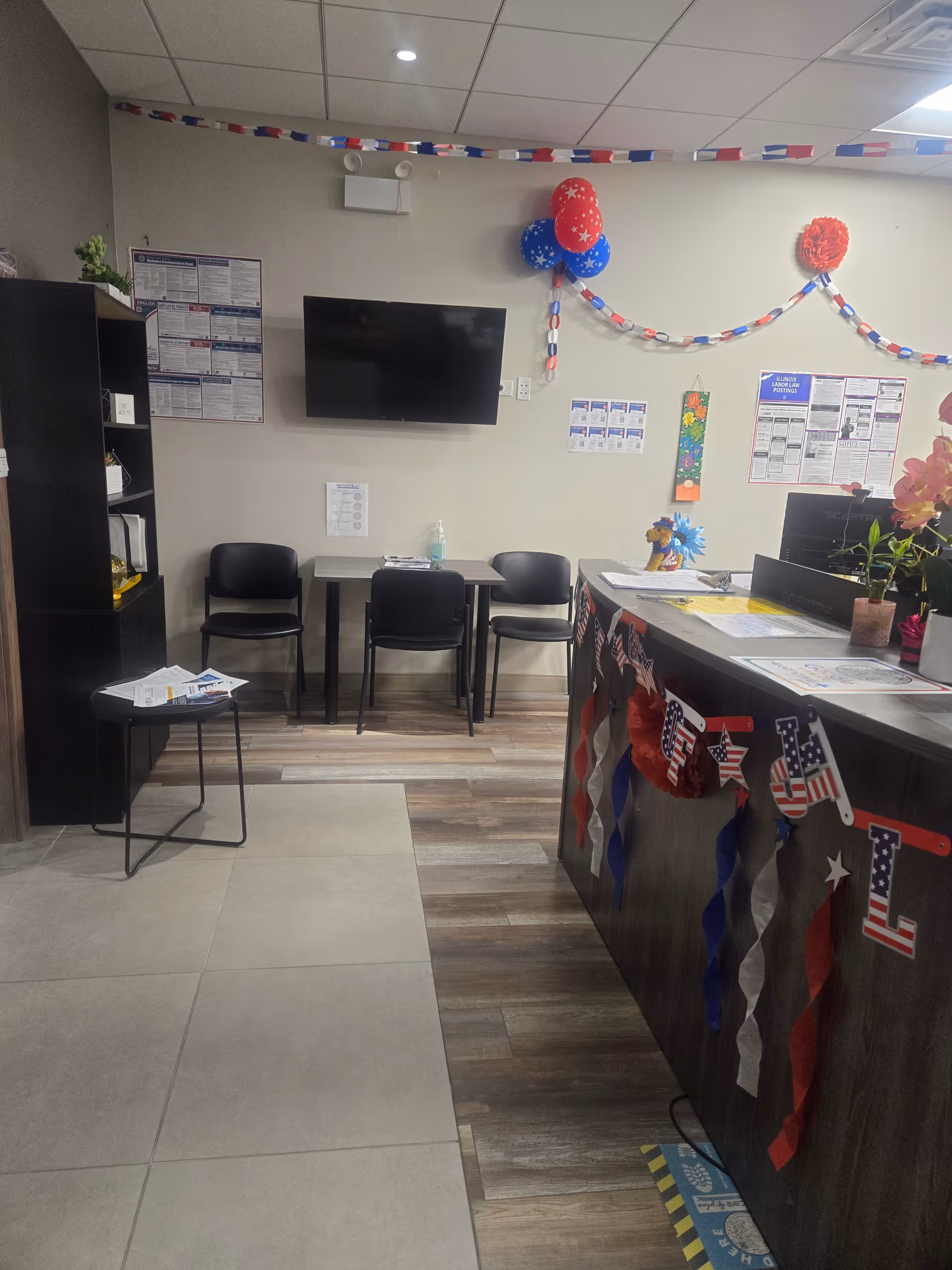 Reception area with festive decorations, a wall-mounted TV, and seating in a senior facility.
