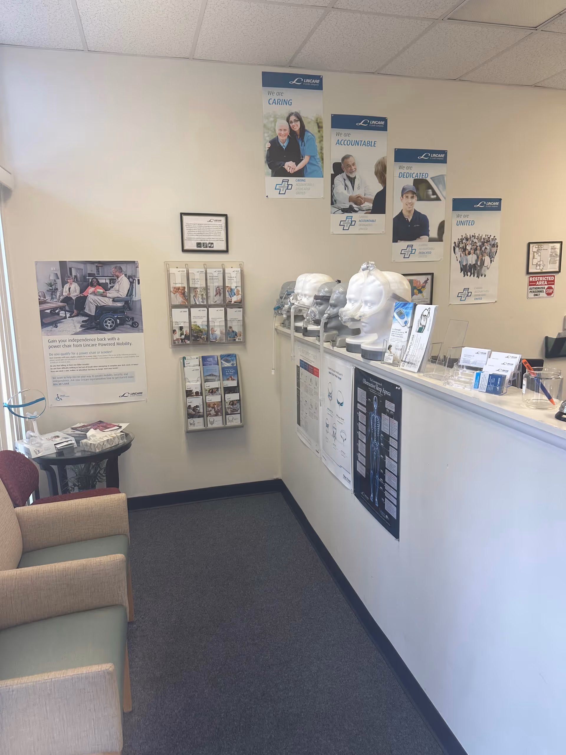 Interior LINCARE reception area with brochures, posters, and a front counter.