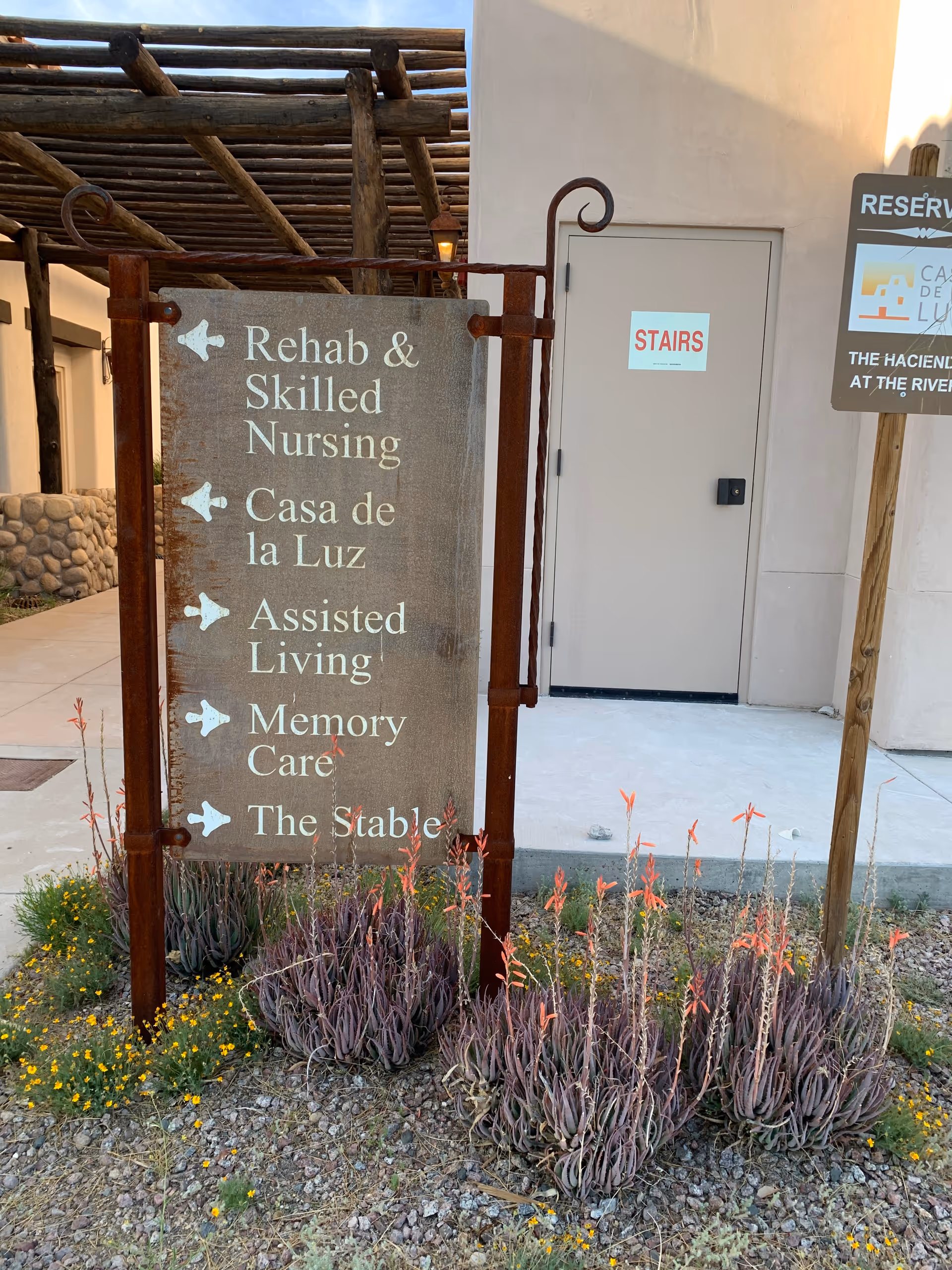 Outdoor signboard listing Rehab & Skilled Nursing, Casa de la Luz, Assisted Living, Memory Care.