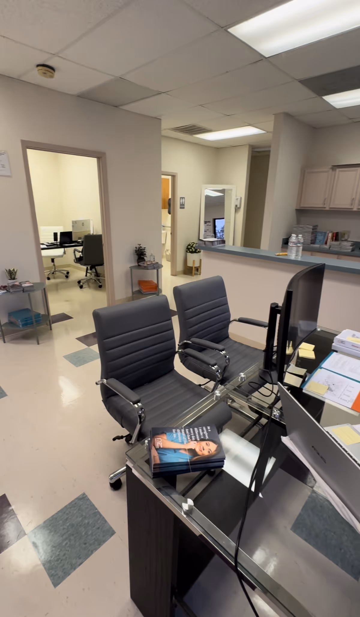 Reception desk with two chairs in a bright senior care office interior