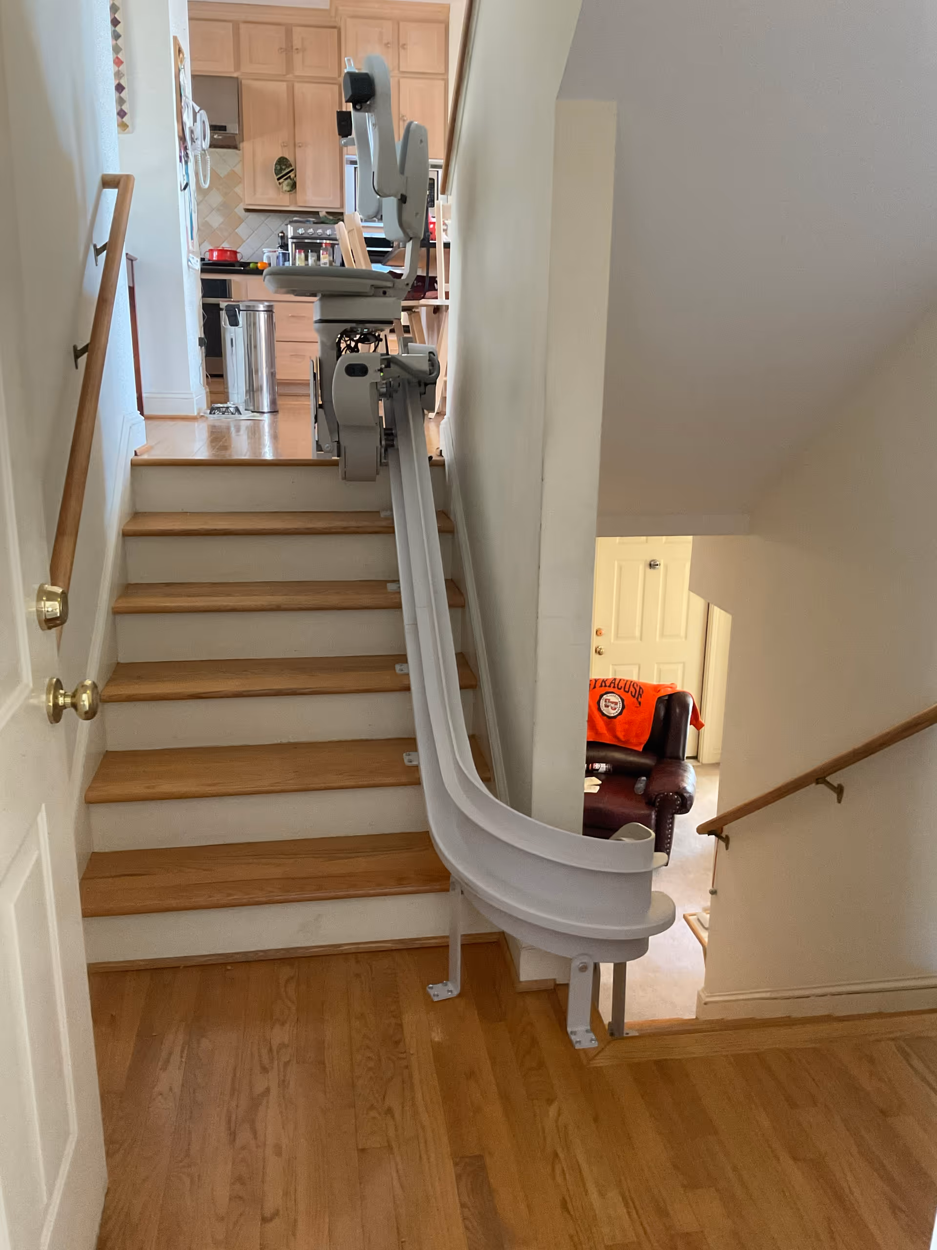 Chairlift installed along a wooden staircase in a home's interior.