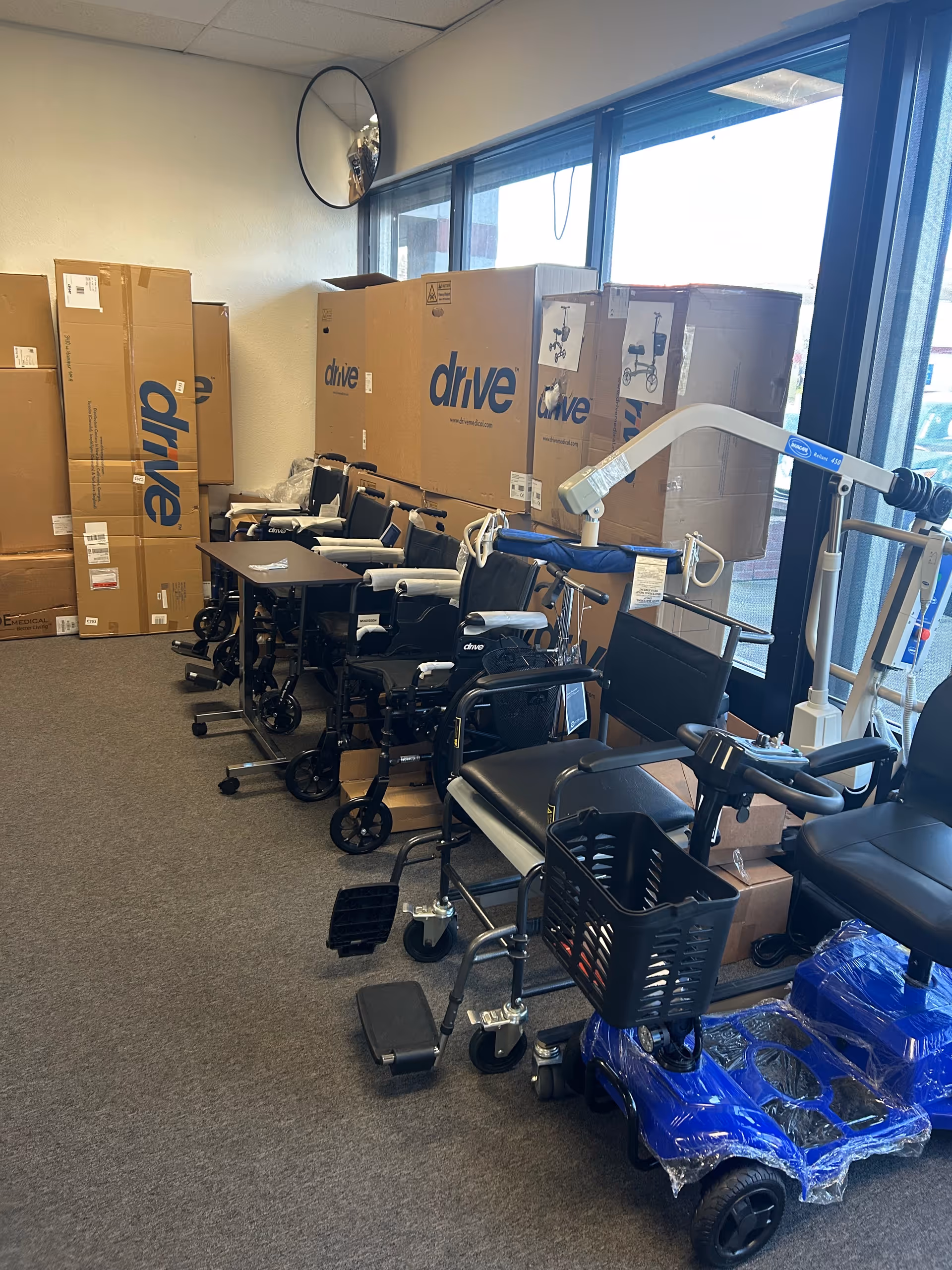 Equipment storage room at Aldo Home Care & Medical Supply, with wheelchairs and boxed medical supplies.