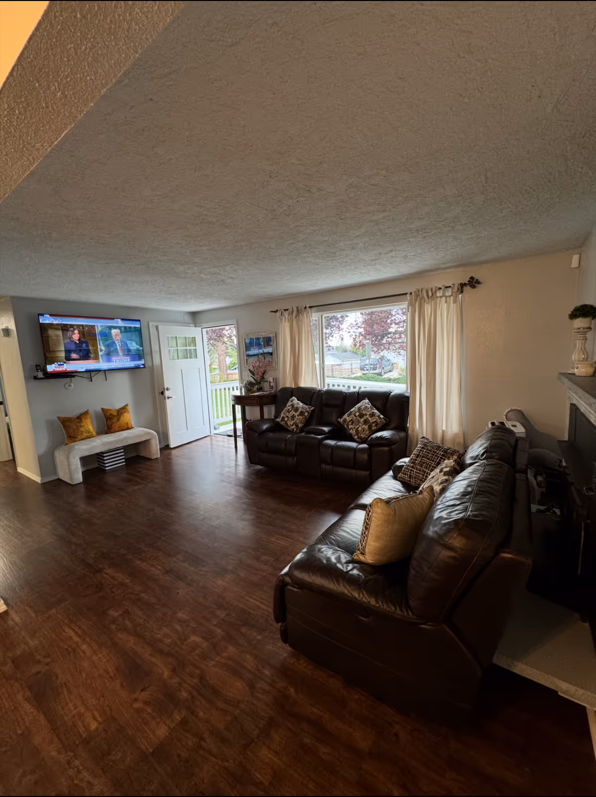 Cozy living room in a senior facility with leather sofas and windows.