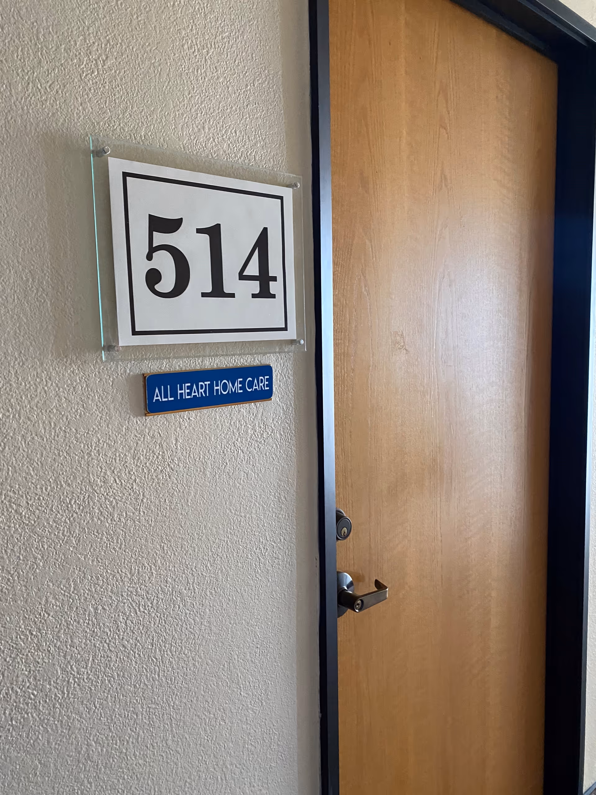 Interior hallway door labeled 514 with All Heart Home Care sign.
