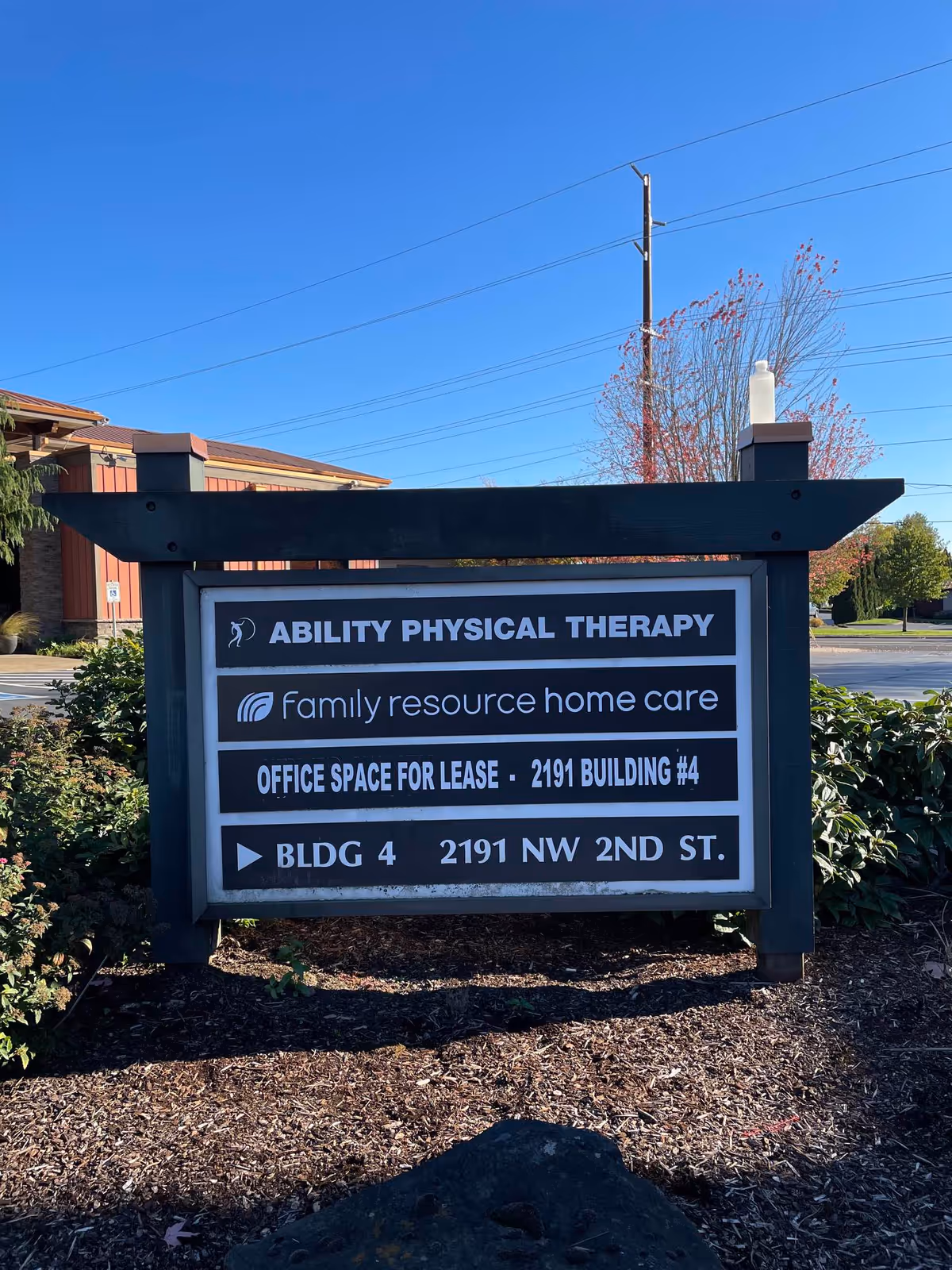 Exterior sign display for Ability Physical Therapy and Family Resource Home Care outside a building.