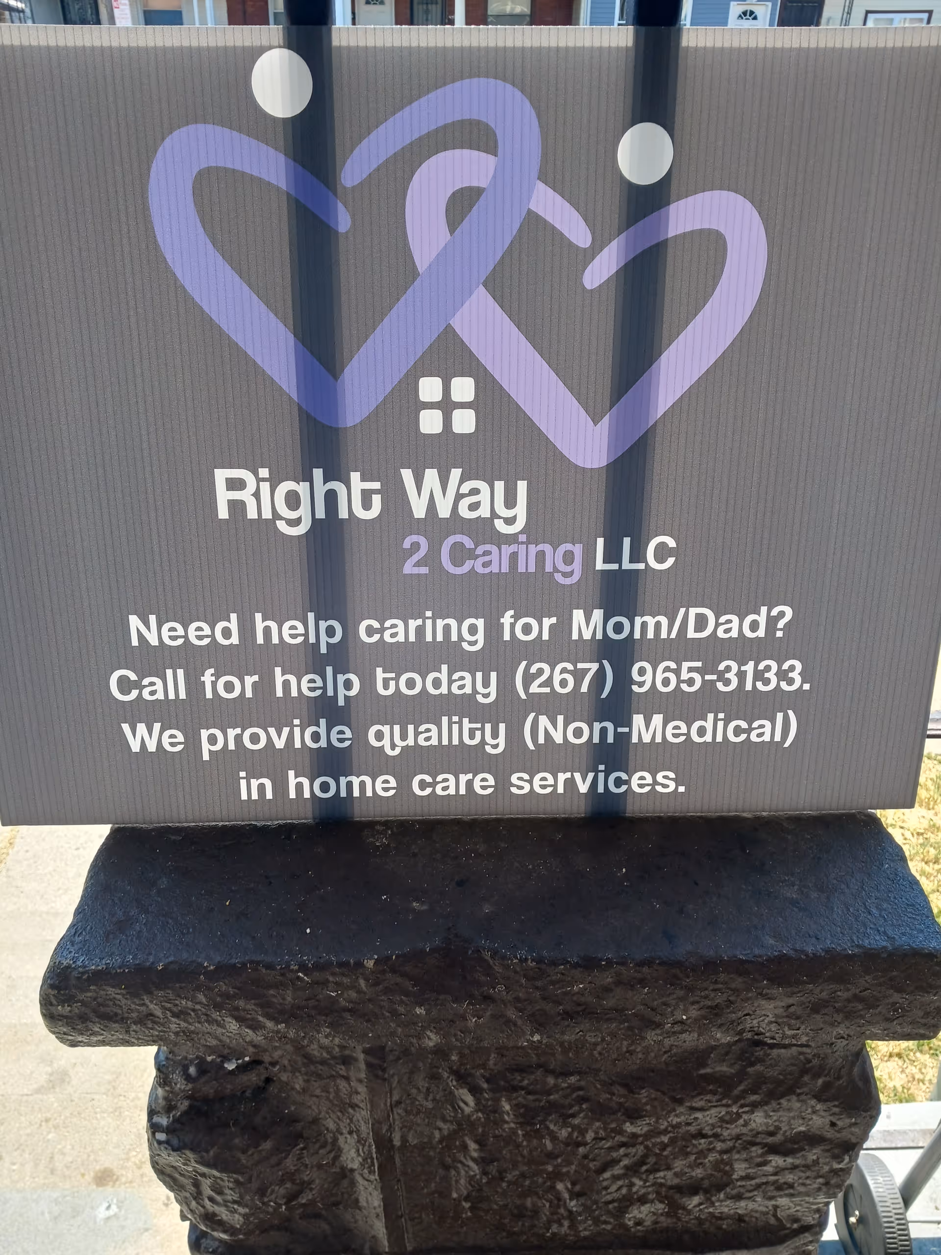 Outdoor sign for Right Way 2 Caring LLC with purple heart logos and text.