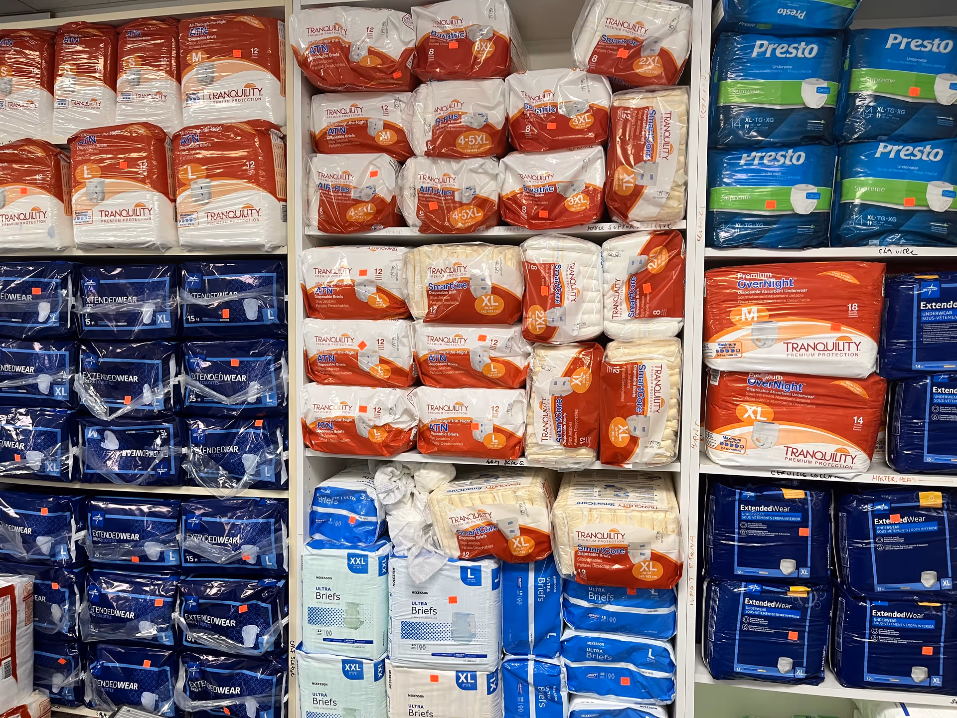 Shelves stocked with assorted adult incontinence briefs and protective underwear packages.