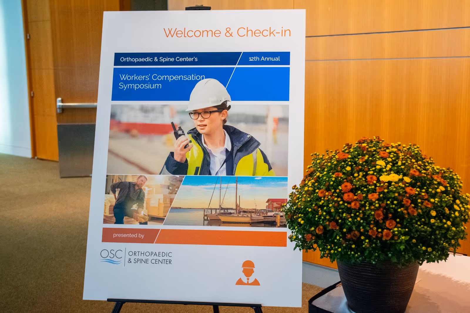 Welcome and Check-in signboard for Orthopaedic and Spine Center beside a potted plant