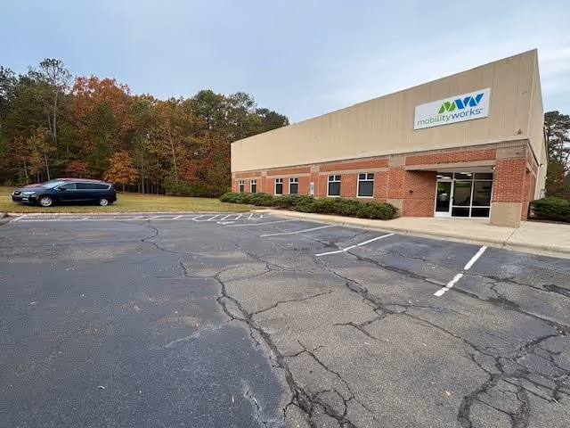 Exterior view of MobilityWorks building with brick facade and surrounding parking.