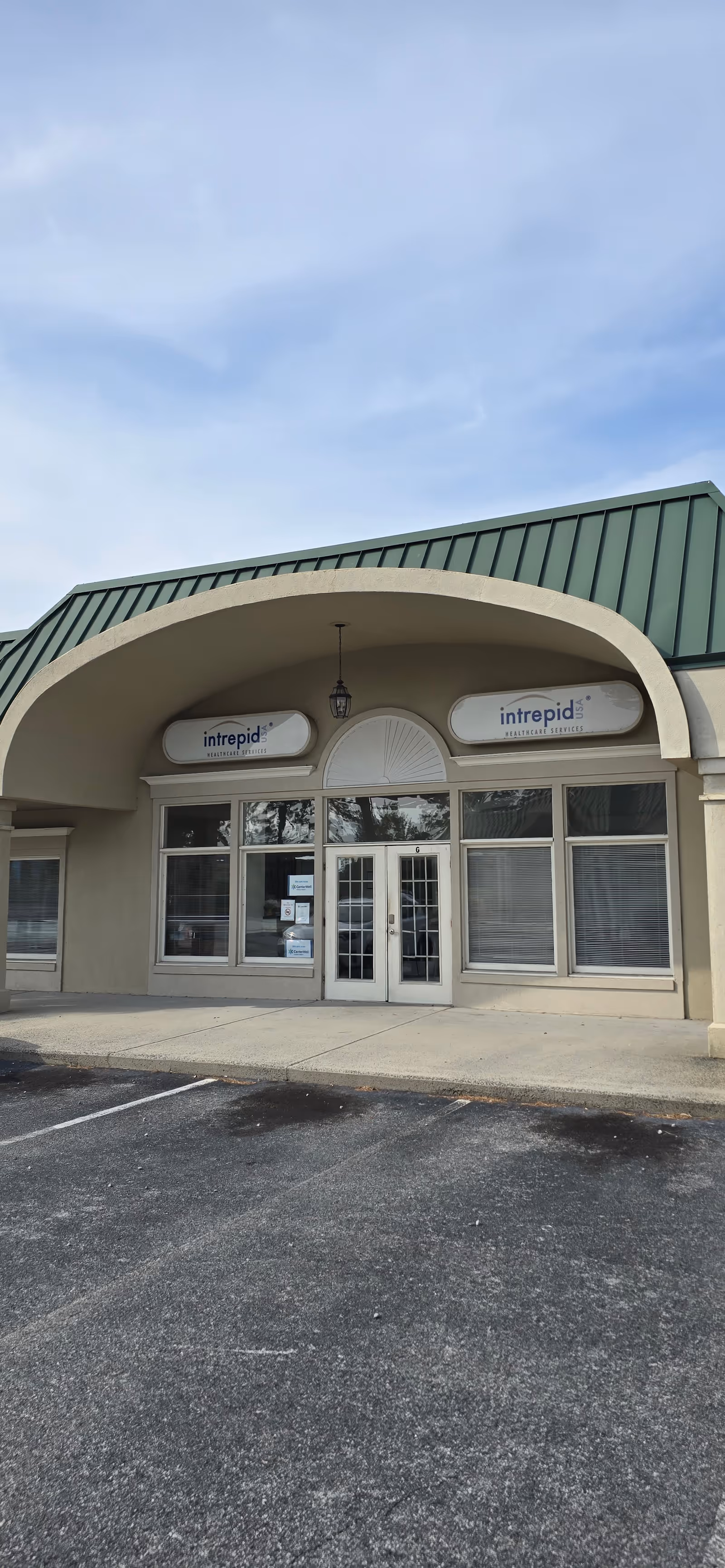 Front view of CenterWell Home Health building with arched canopy.