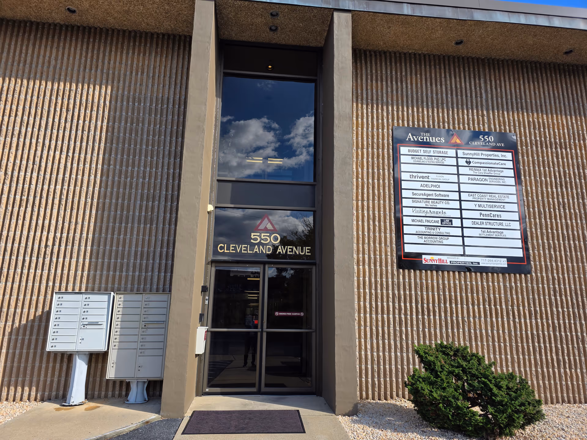 Exterior view of a brick building entrance at 550 Cleveland Avenue with signage.