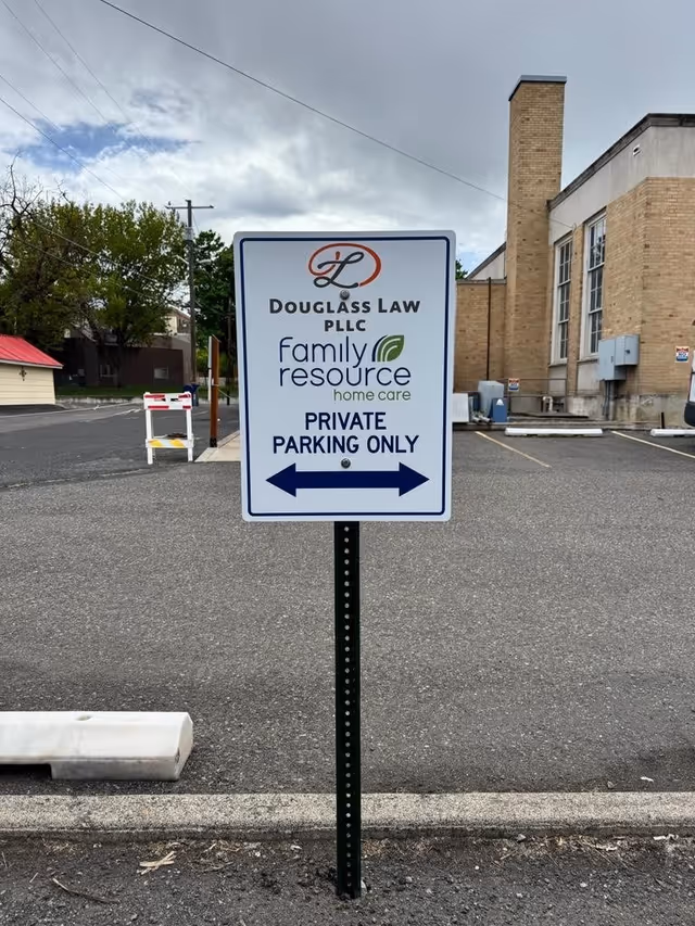 Paved parking lot with a Family Resource Home Care sign beside a brick building.