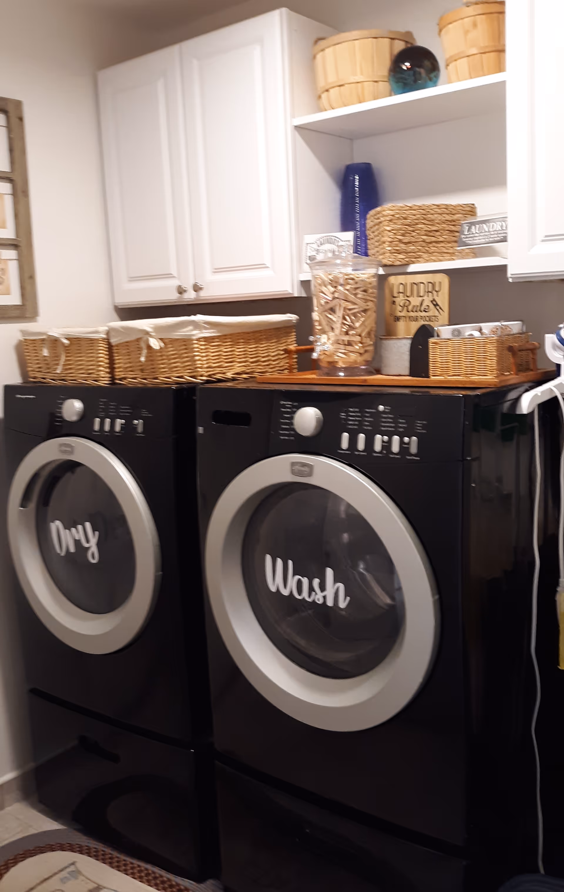 Two front-loading washers labeled 'Wash' and 'Only' in a laundry room.