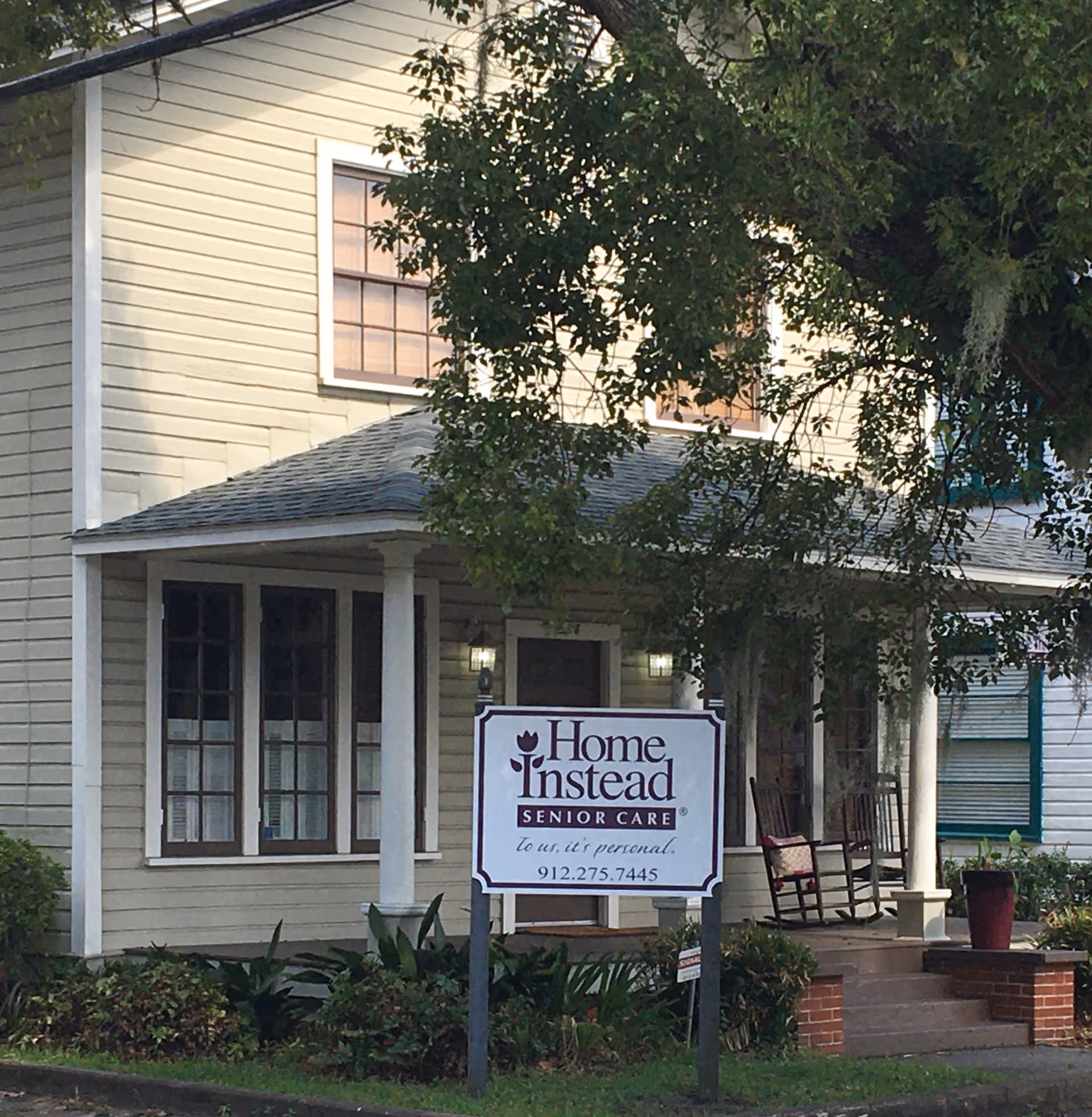 Exterior view of a Home Instead Senior Care building with a front entrance and sign