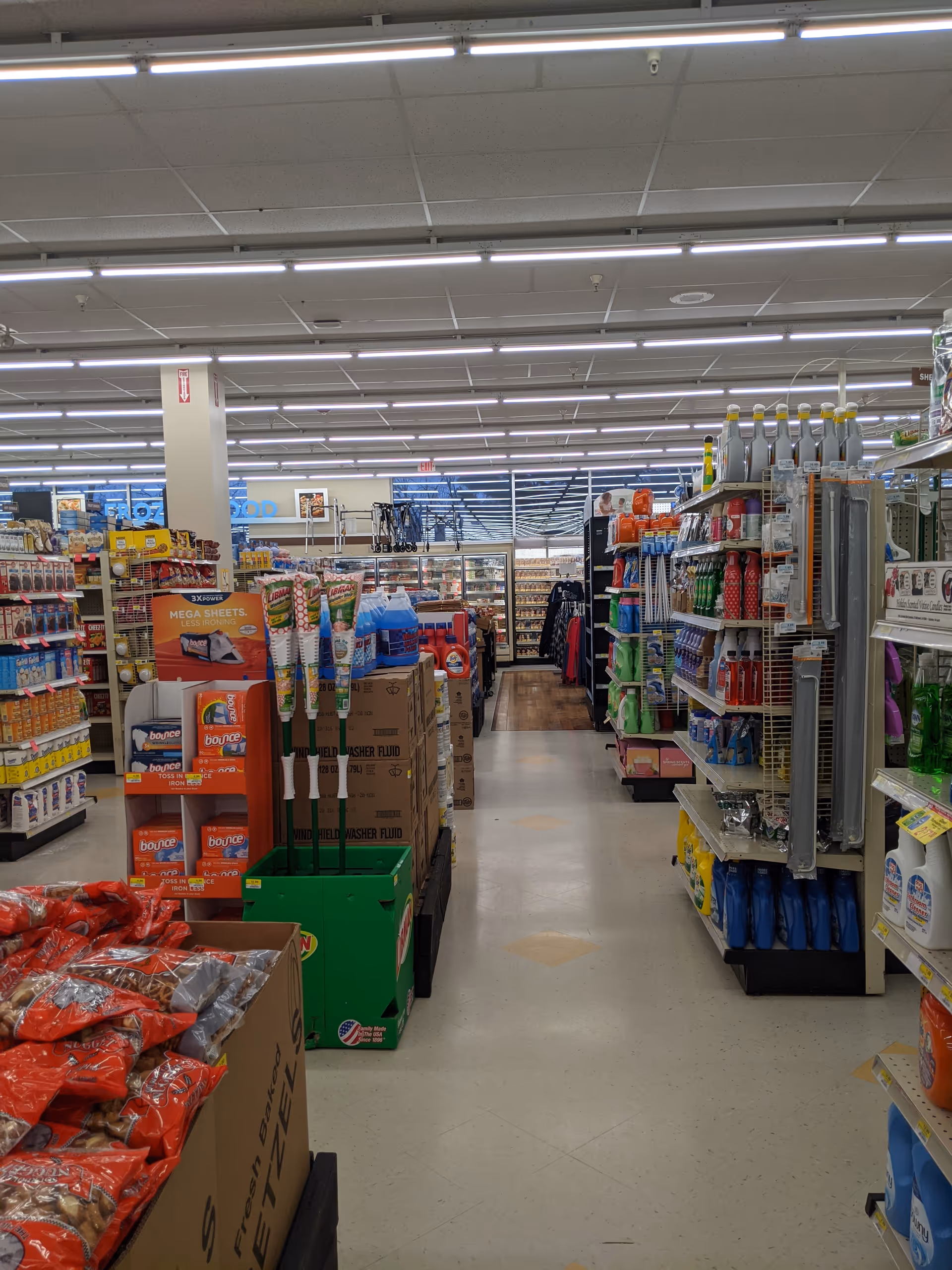 Inside a Discount Drug Mart store with aisles of products and bright lighting.