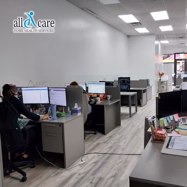 Open office area inside a senior care facility with multiple desks and computer screens.