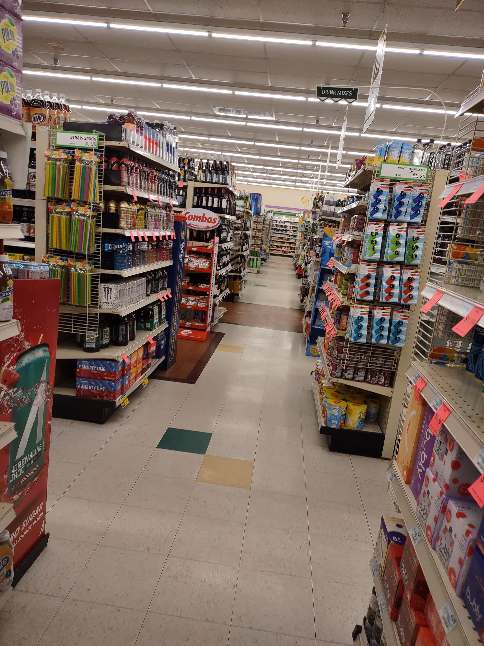 An indoor Discount Drug Mart aisle with tall shelves and assorted products.