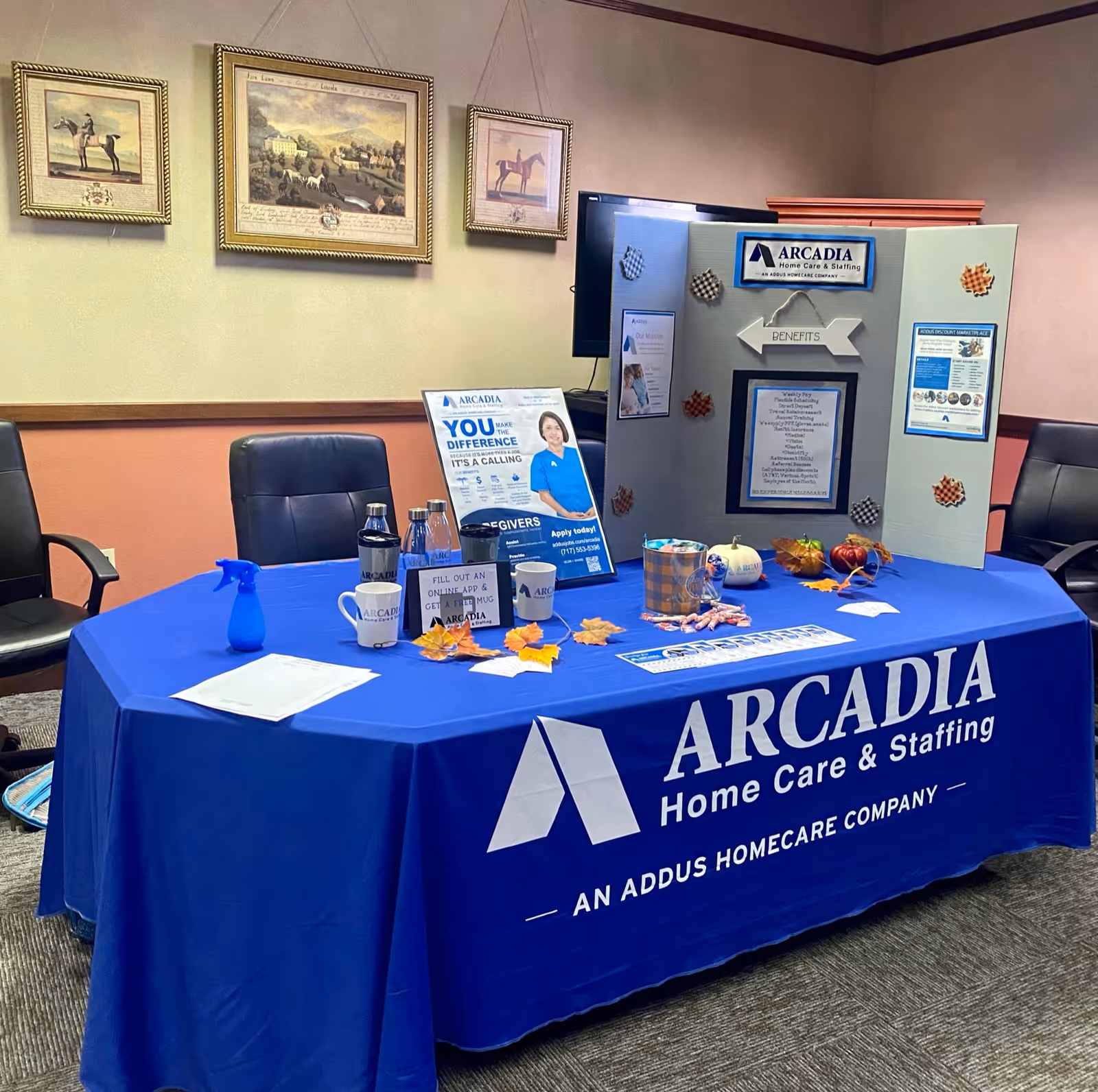 Indoor conference table with Arcadia Home Care & Staffing promotional display and brochures.