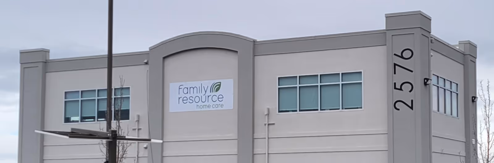 Exterior view of a Family Resource Home Care building with a tall vertical address pillar.