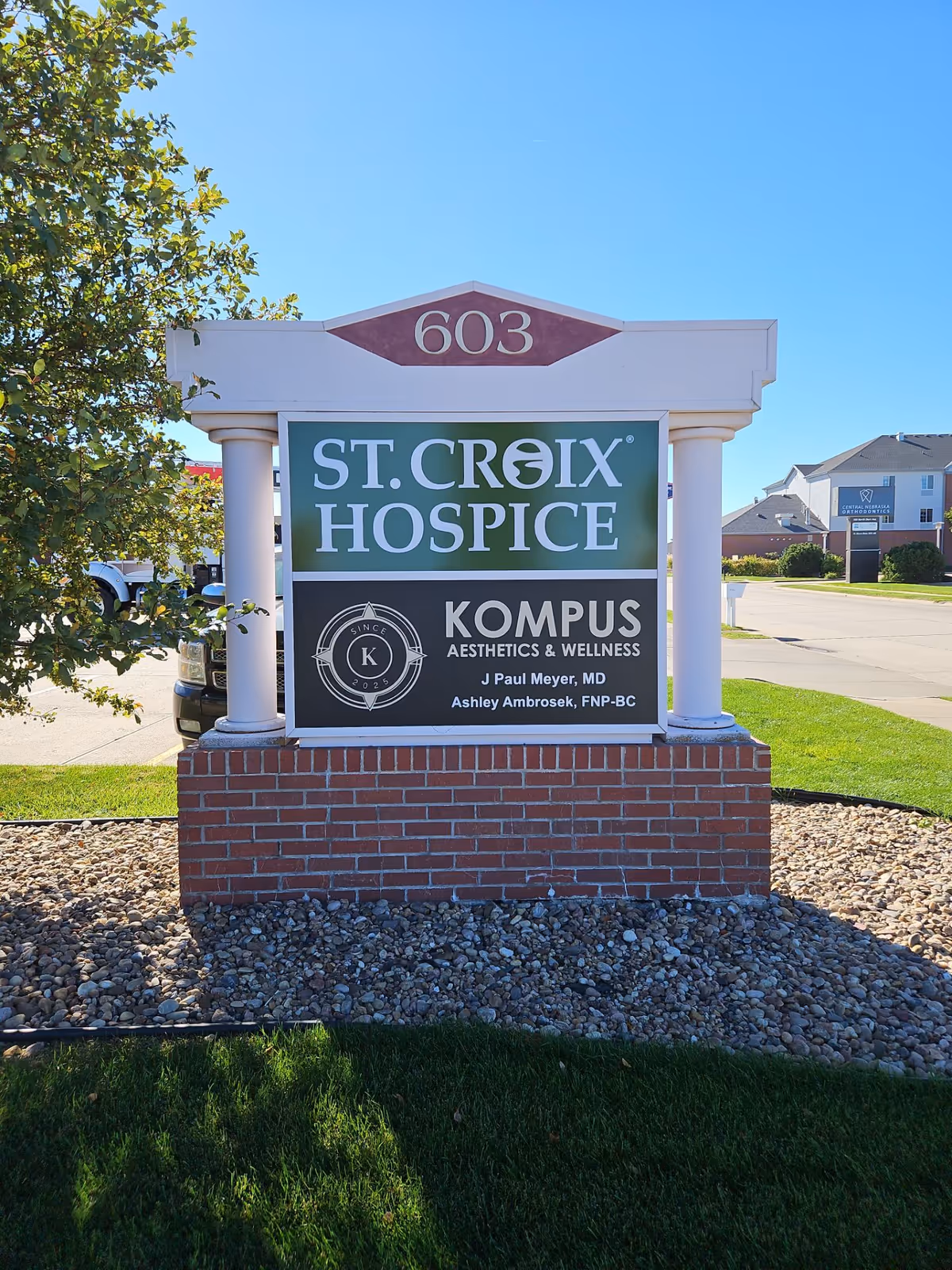 Outdoor sign reads 'St. Croix Hospice' with Kompus Aesthetics & Wellness branding.