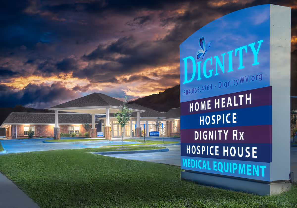 Evening exterior view of Dignity Hospice & Home Health with an illuminated sign.