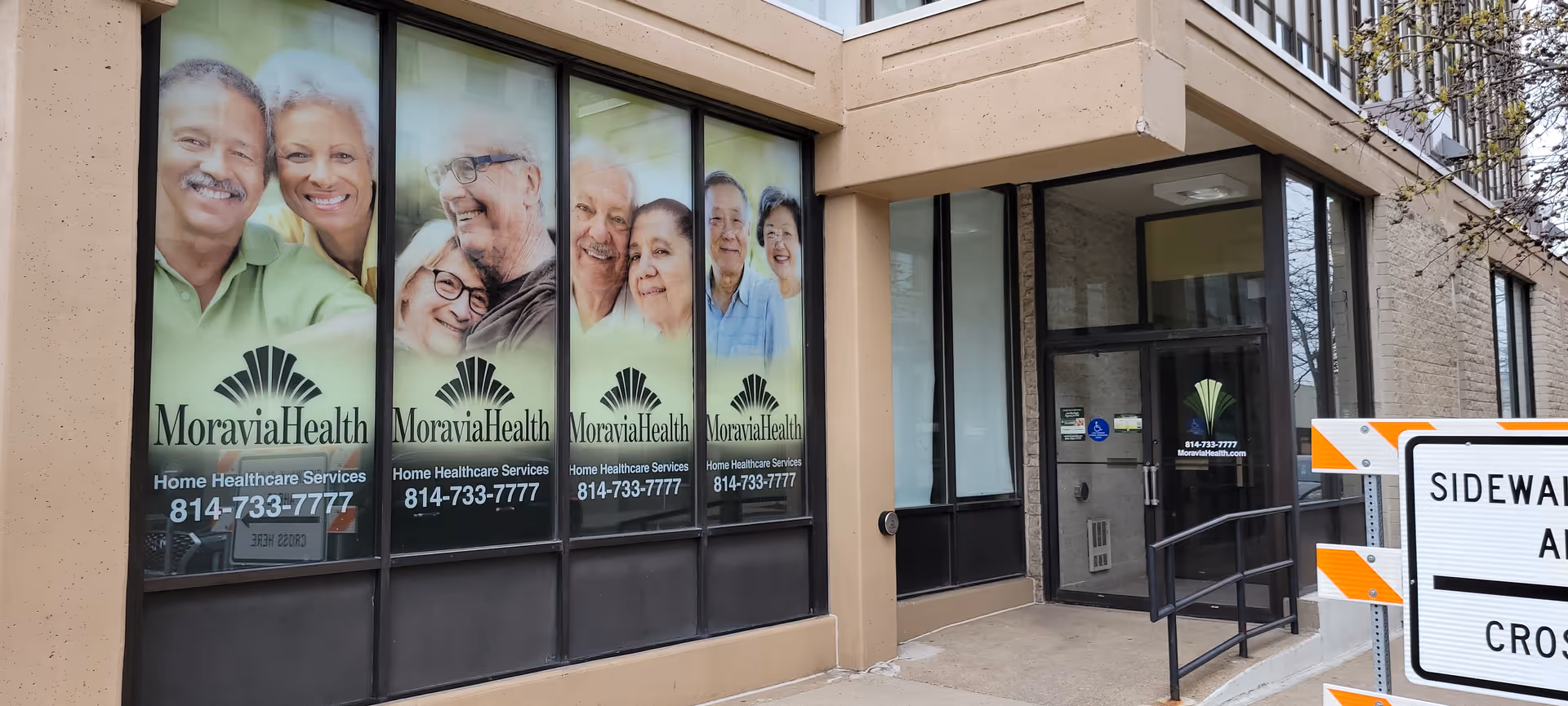 Exterior view of Moravia Health Erie with large window advertisements and the entrance door.