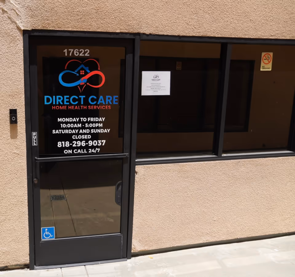 Front view of a beige building with a glass door labeled Direct Care Home Health Services.