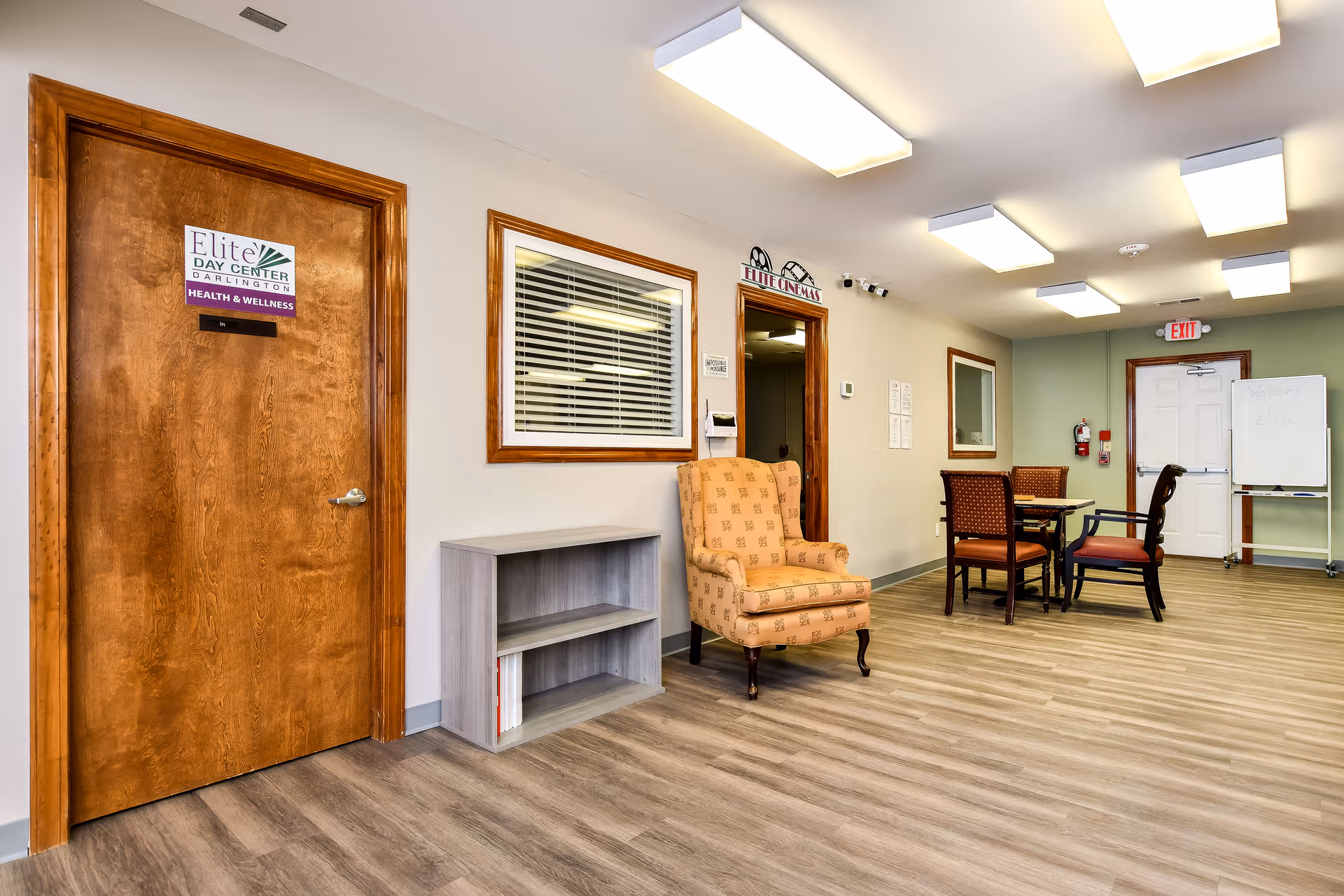 Interior lobby area of Elite Home Care and Day Centers with seating and a labeled door.