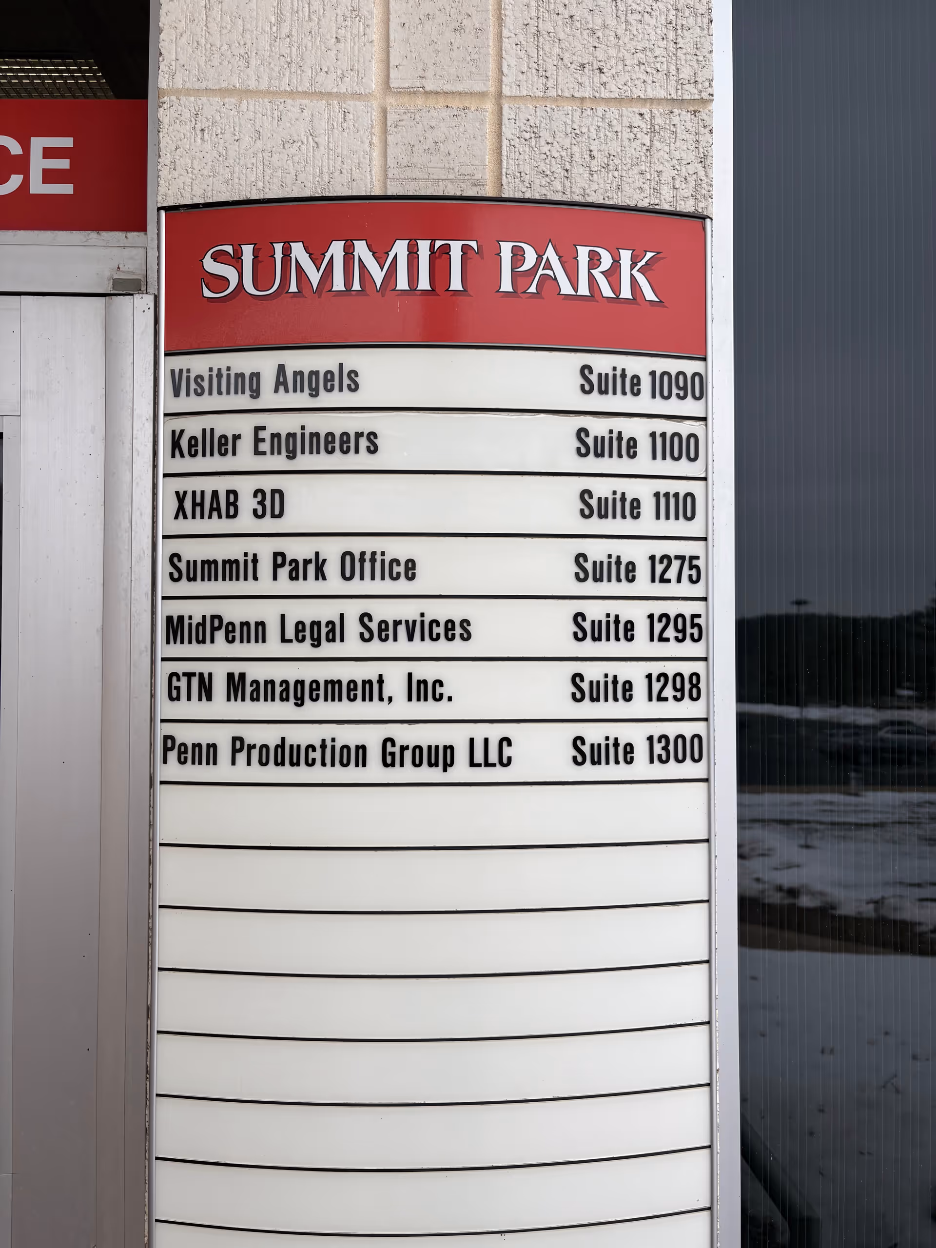 Exterior signboard at Summit Park listing tenants including Visiting Angels.