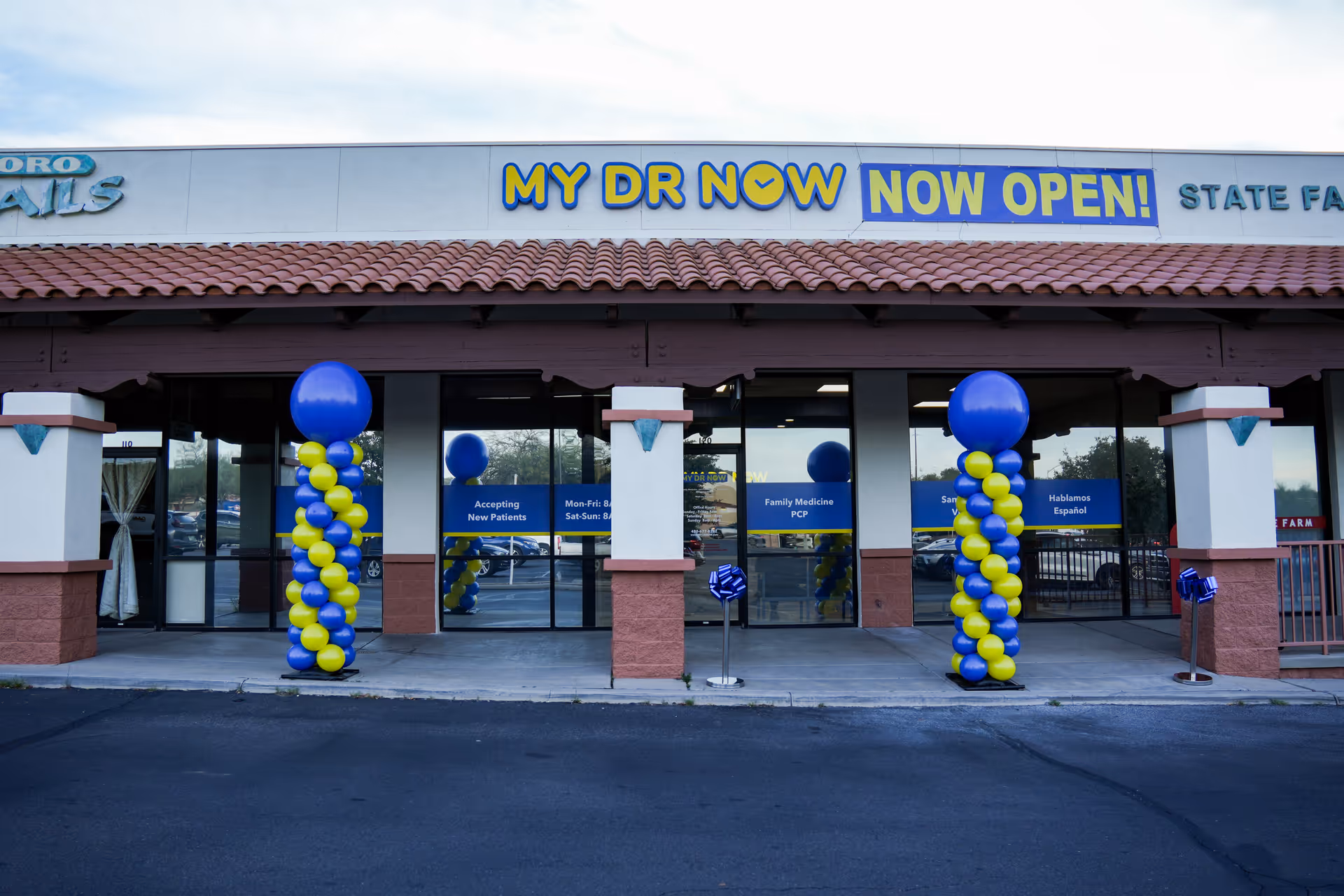 Exterior storefront with a 'MY DR NOW' sign and blue-yellow balloon decorations.