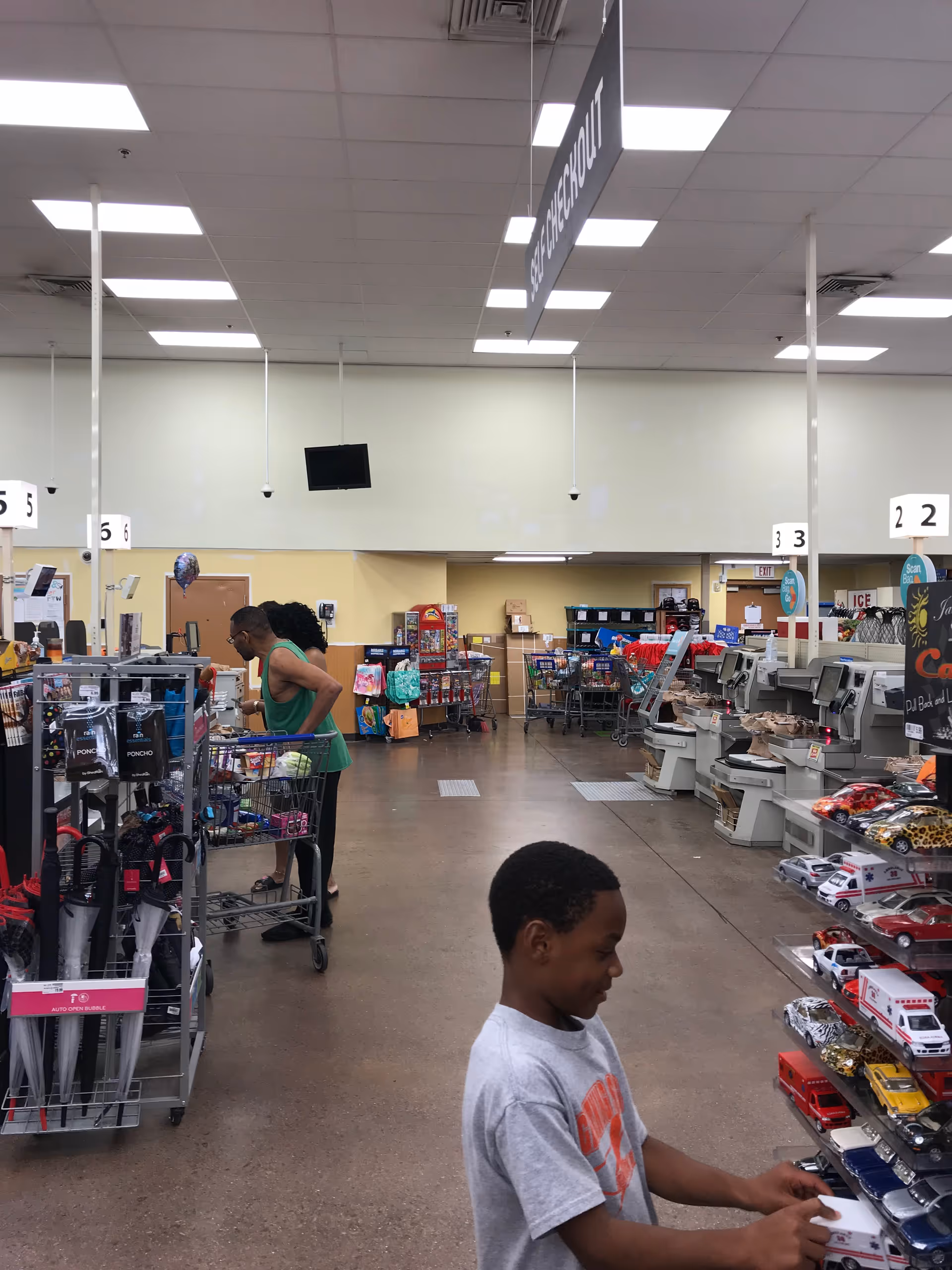 Interior of a Kroger store pharmacy area with shoppers and checkout lanes.