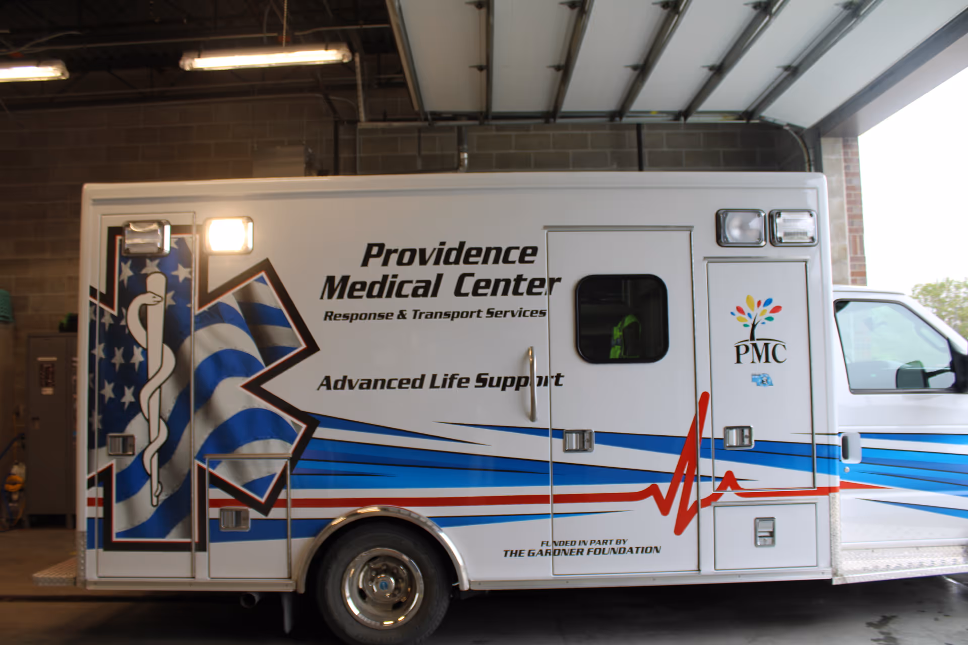 Providence Medical Center ambulance parked inside a hospital service bay.