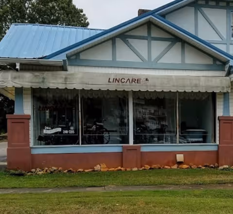 Front exterior of a LINCARE storefront with blue trim and awning.