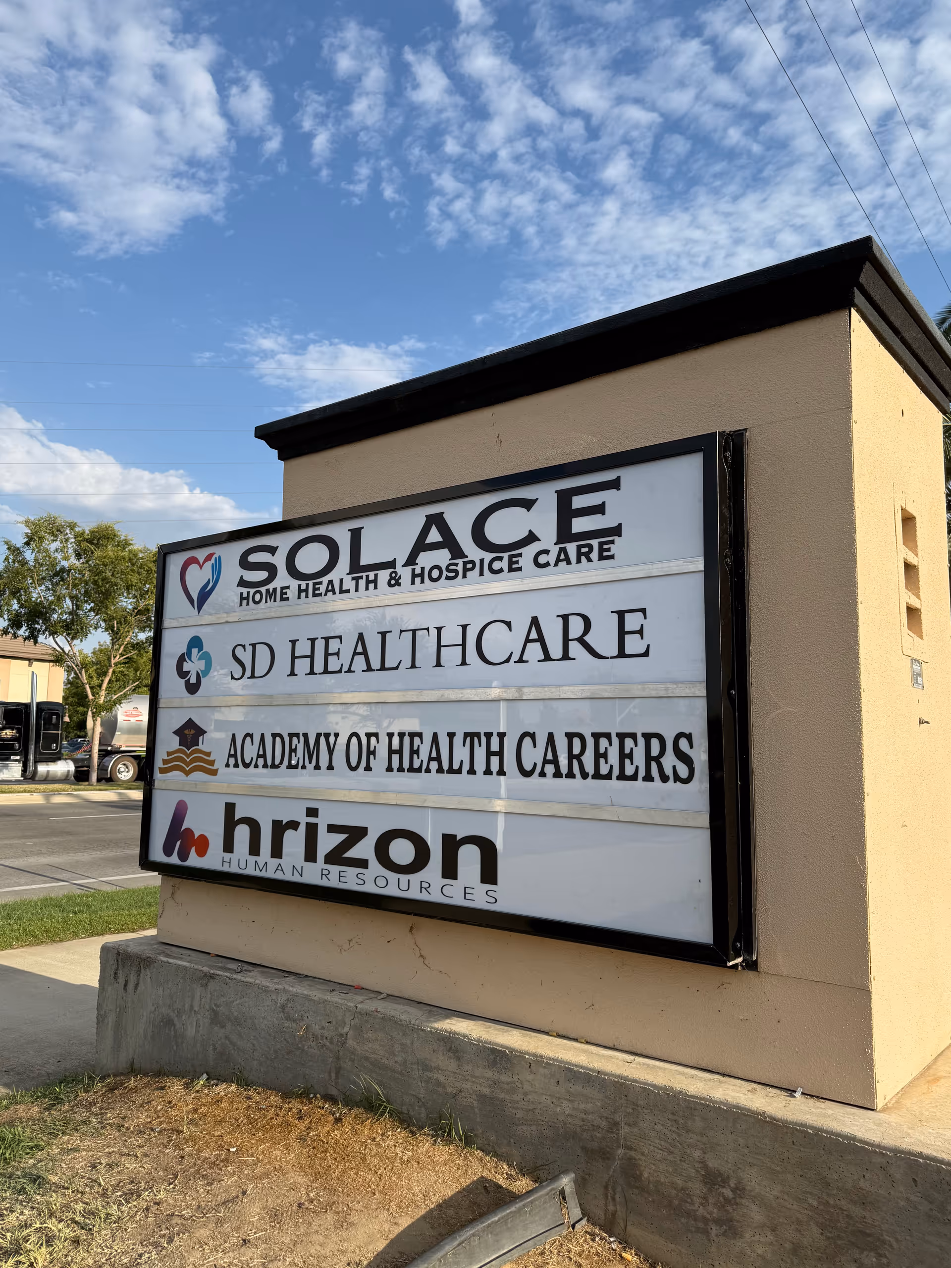 Exterior signboard for Solace Home Health and Hospice Care on a building front
