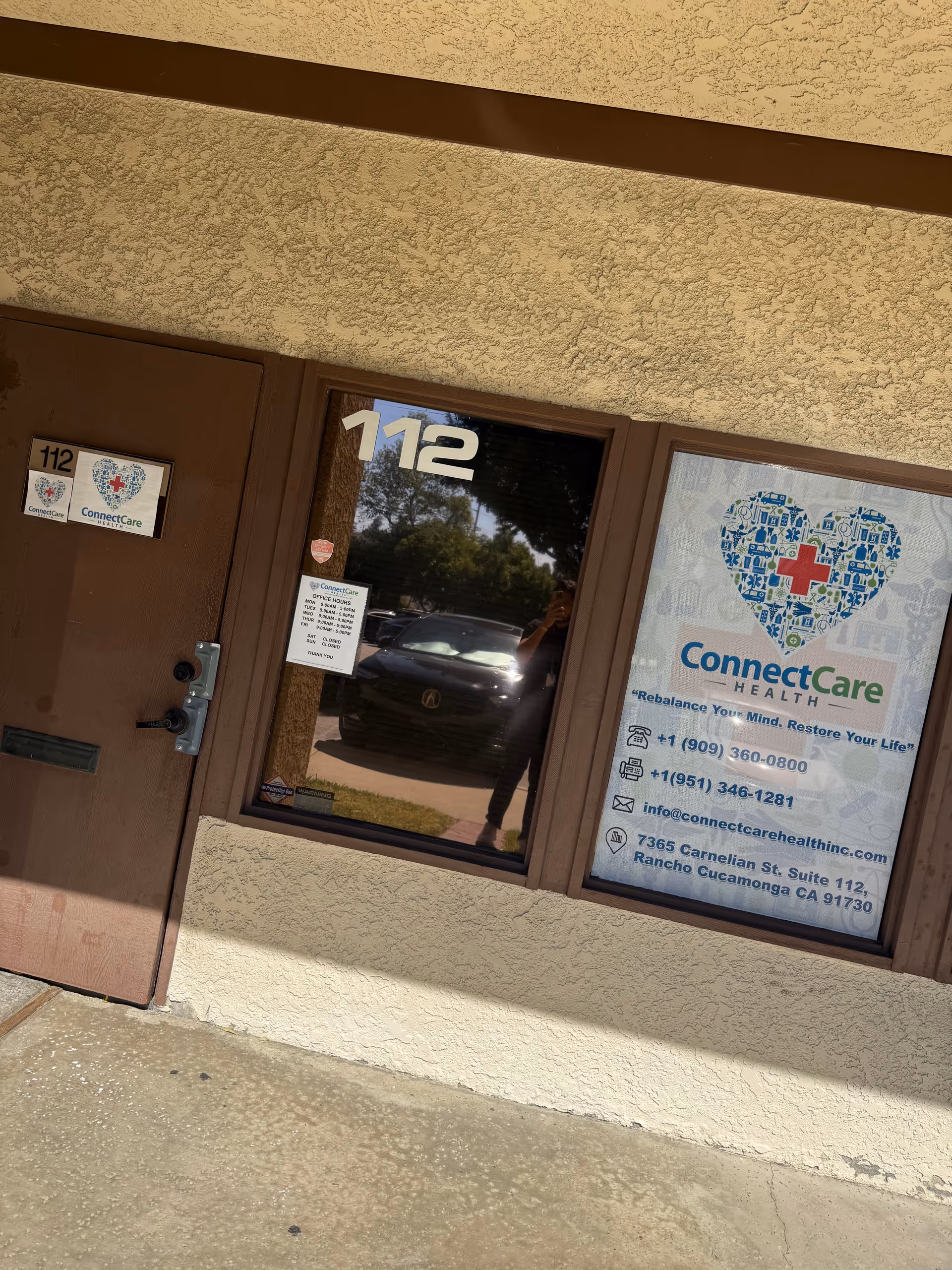 Exterior view of a facility entrance with door 112 and ConnectCare Health signage.