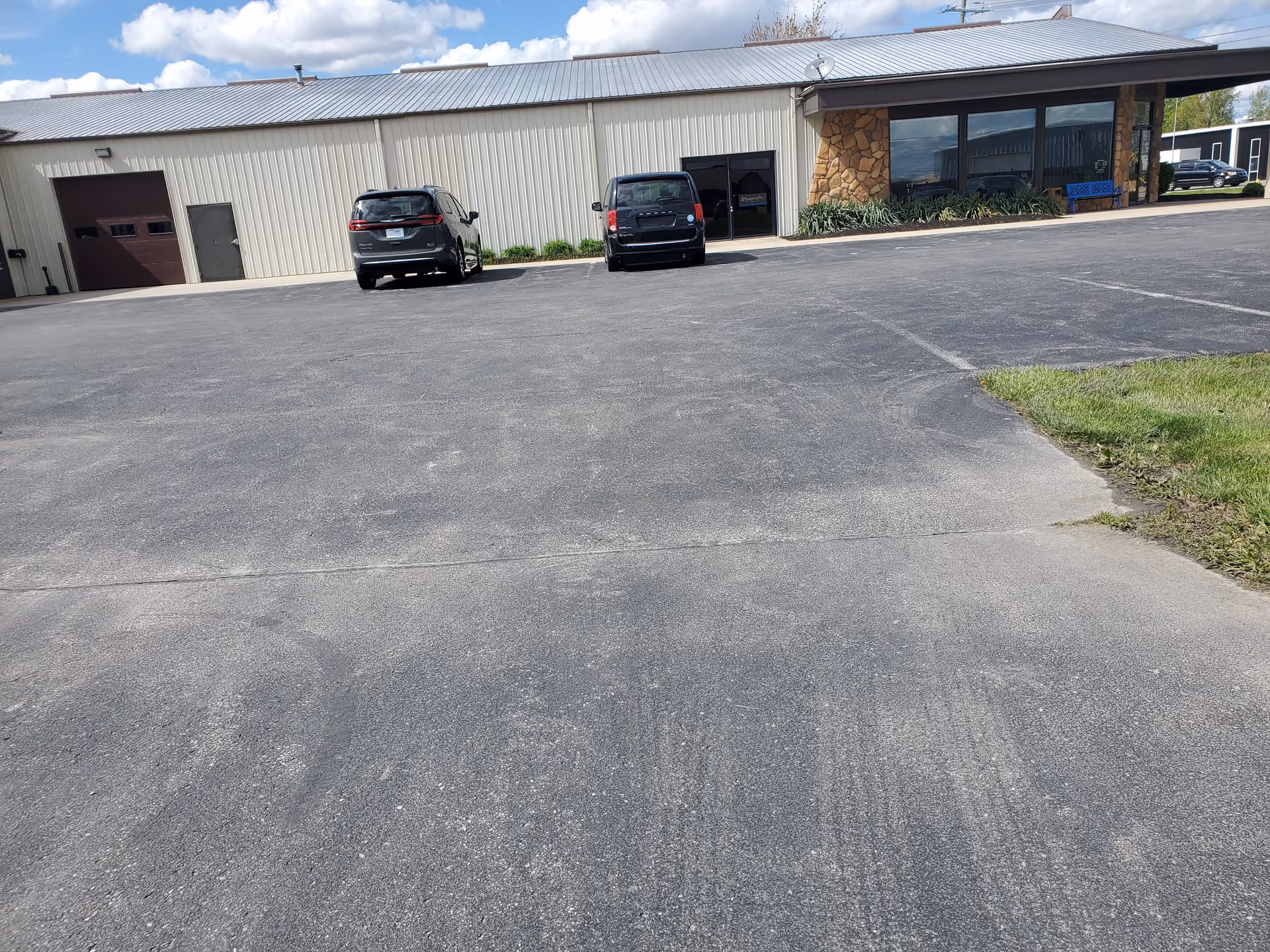 Exterior view of MobilityWorks senior living facility with a parking lot and glass storefront.
