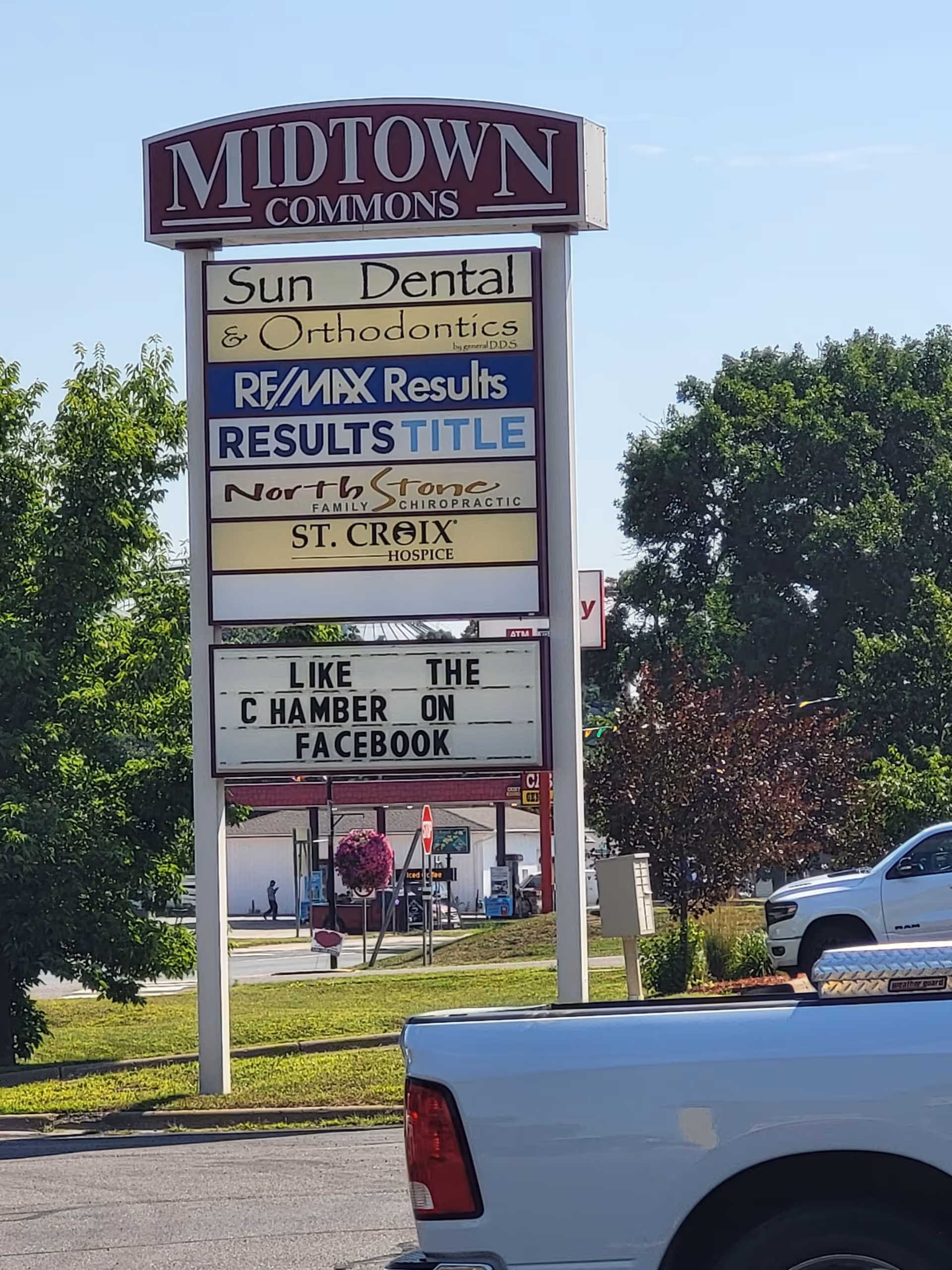 Tall outdoor sign for Midtown Commons listing multiple tenants, including St. Croix Hospice.