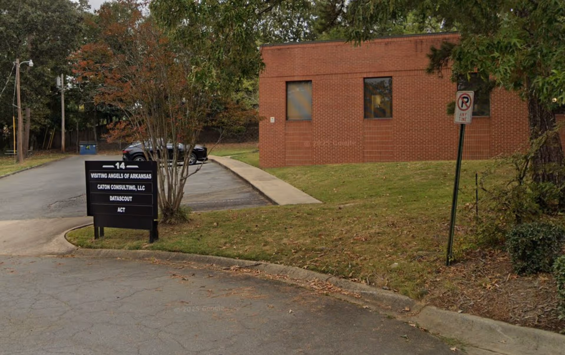 Brick exterior of a Visiting Angels building with a sign and driveway.
