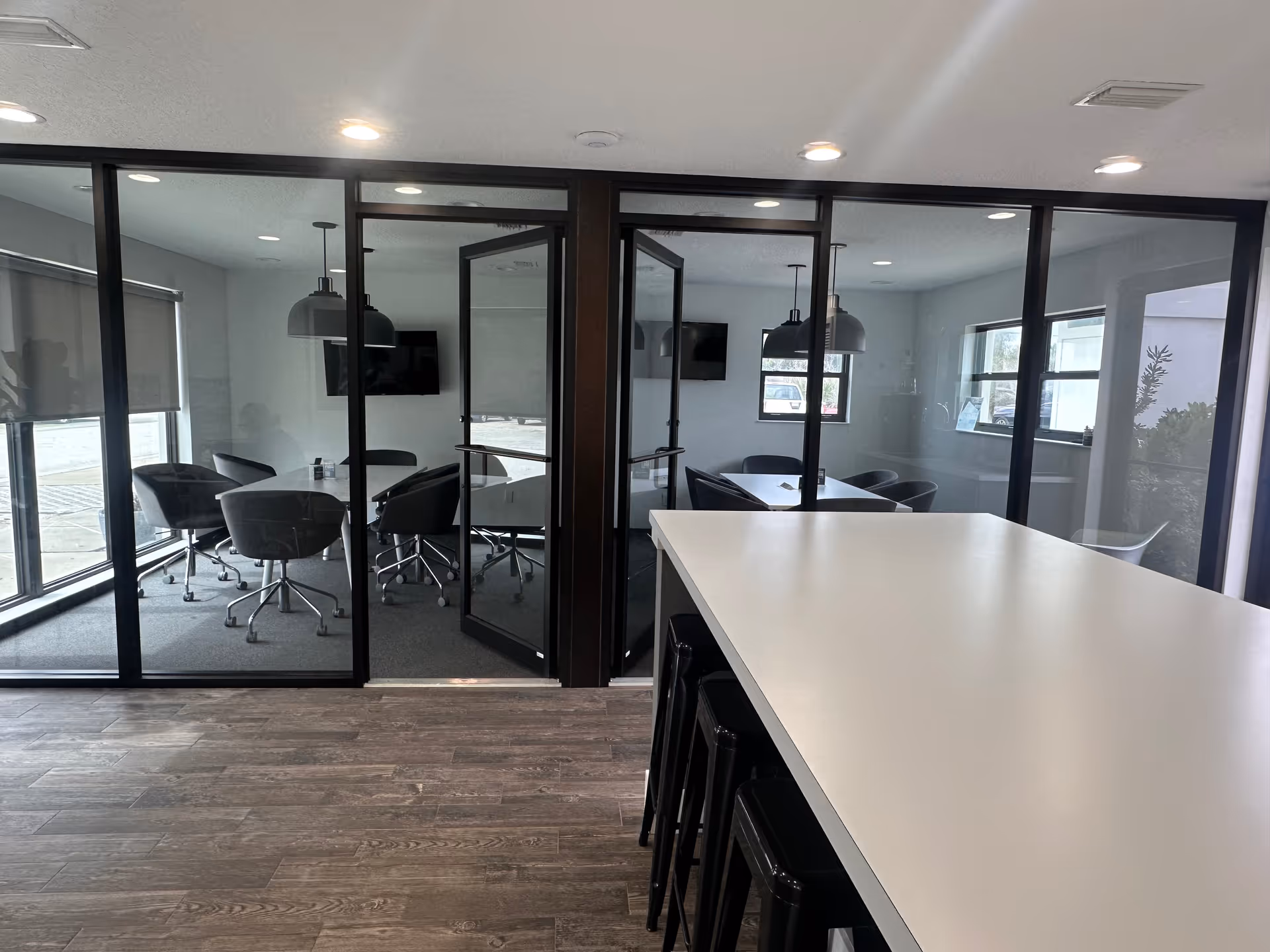 Glass-walled meeting area inside a HomeWell Care Services facility.