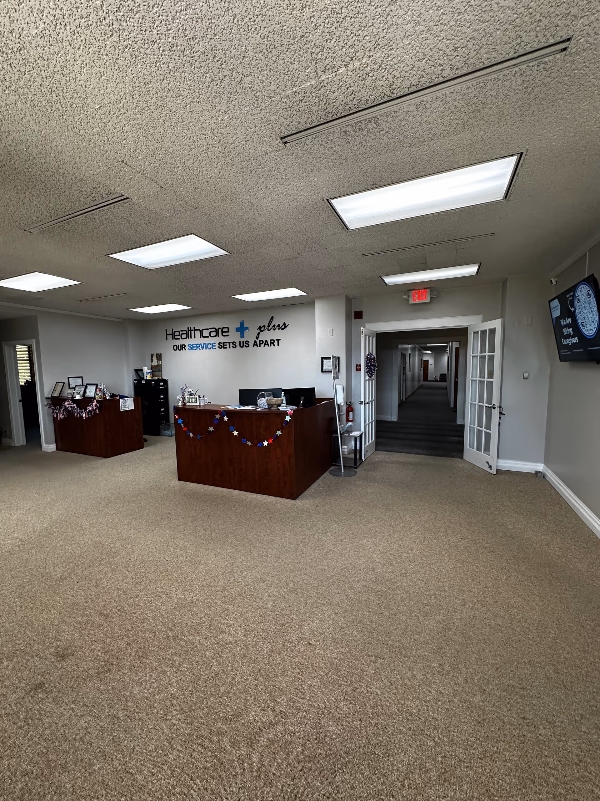 Reception desk in a spacious interior lobby with star garlands and a hallway