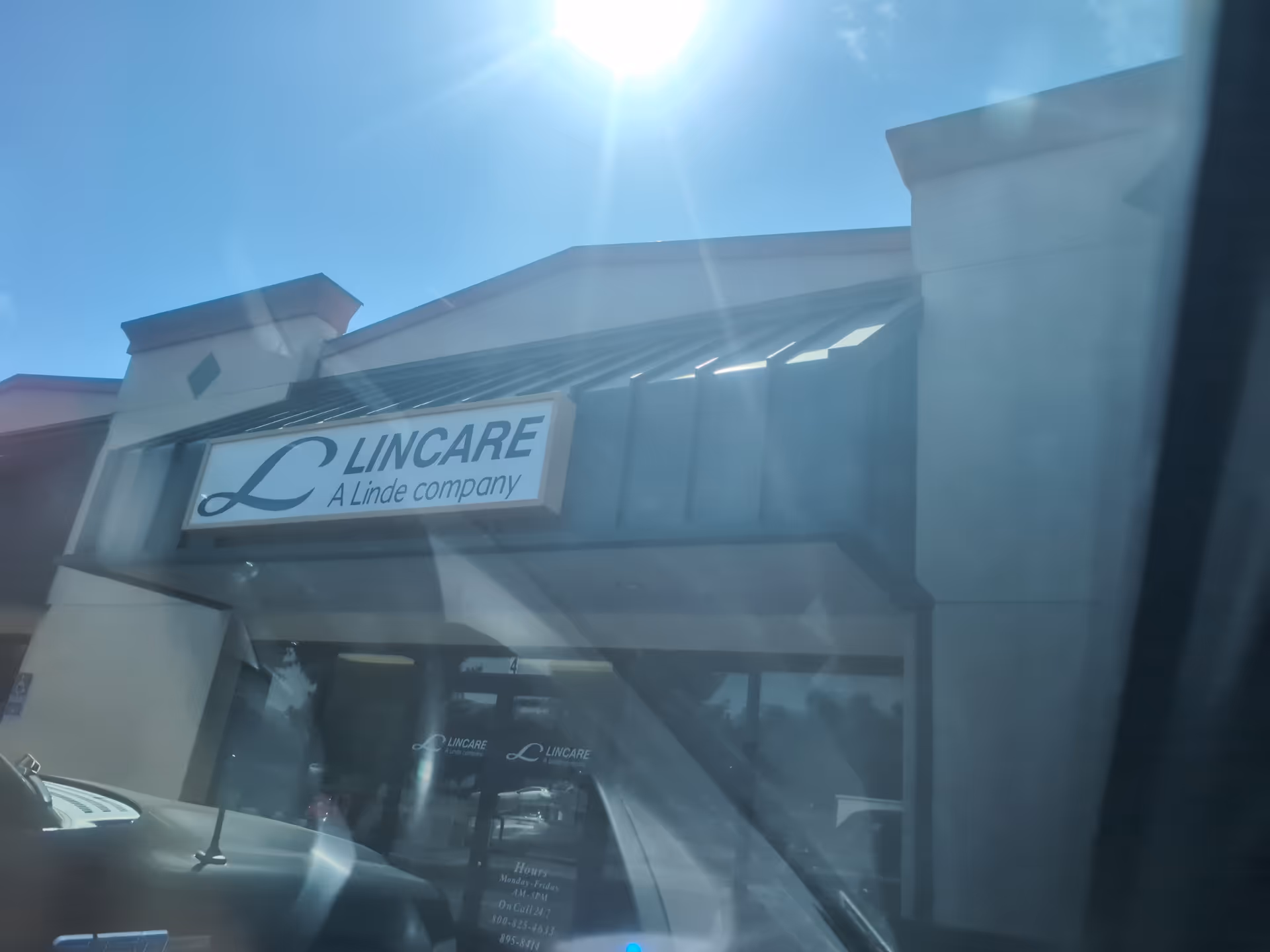 Exterior view of a LINCARE storefront with sign on a sunny day