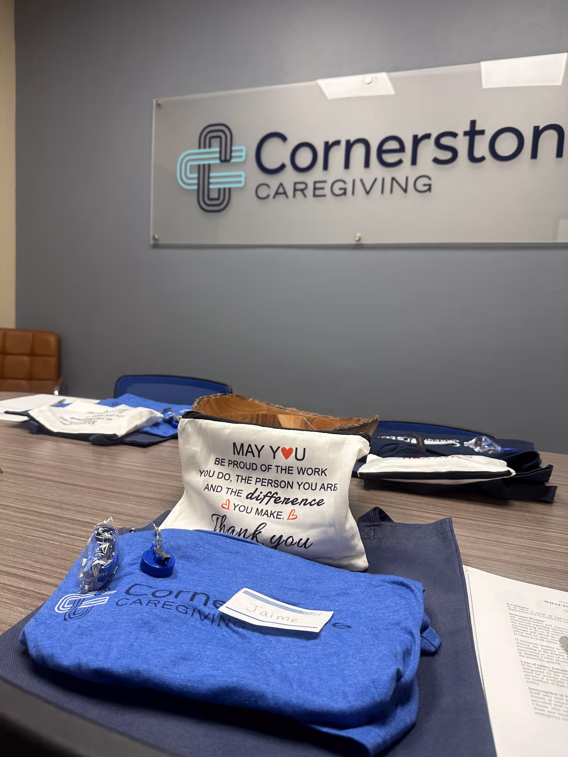 Conference table with Cornerstone Caregiving merchandise in a meeting room
