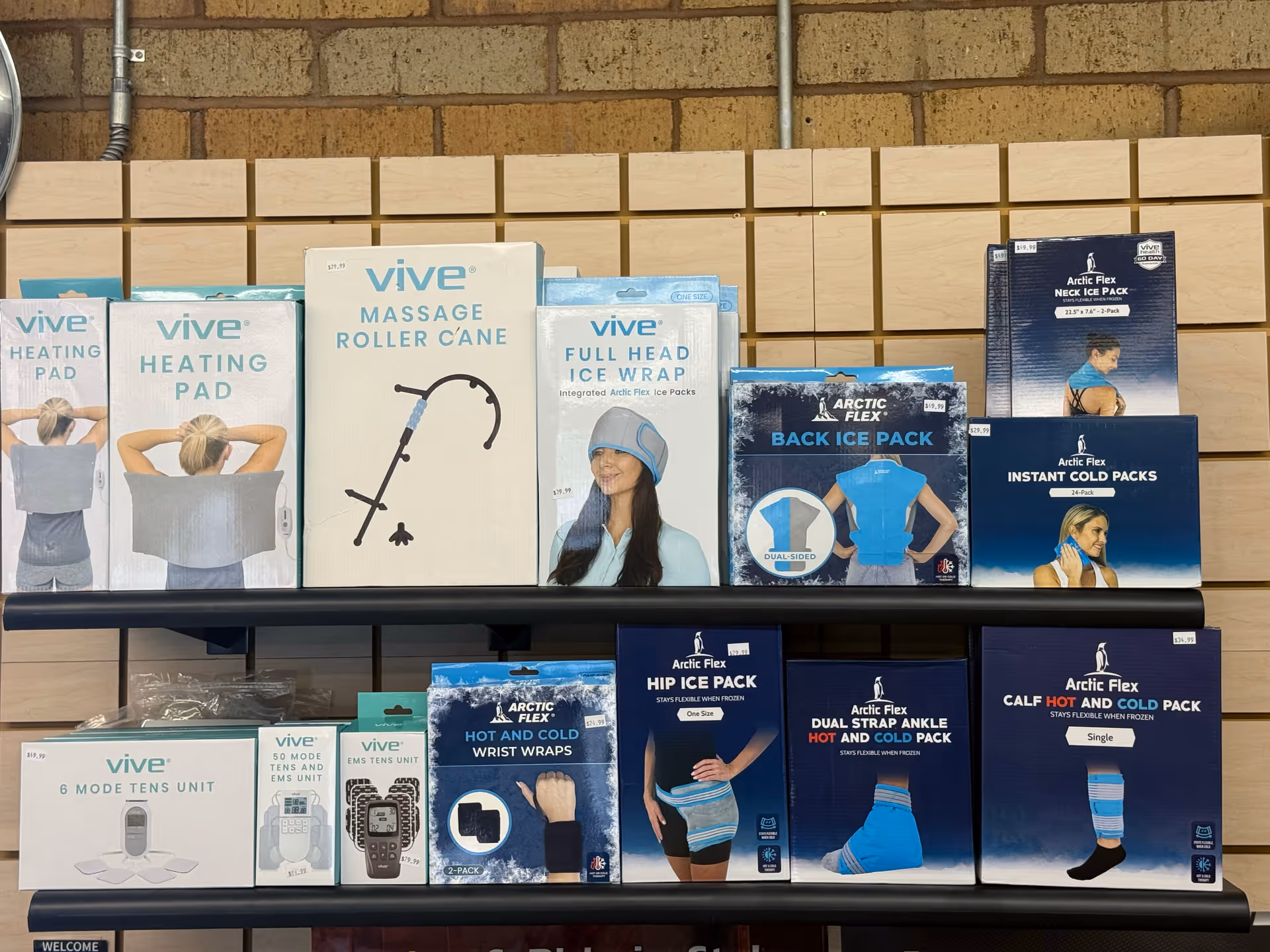 Shelf of Vive and Arctic Flex medical supply boxes on a display rack.