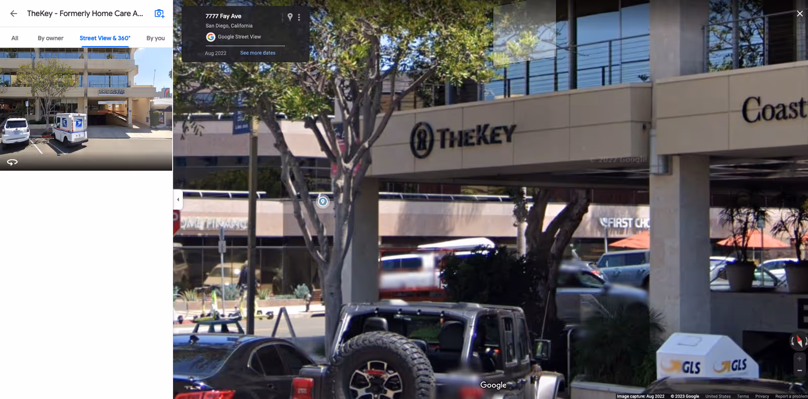 Exterior view of TheKey senior home care building with parked cars along street.