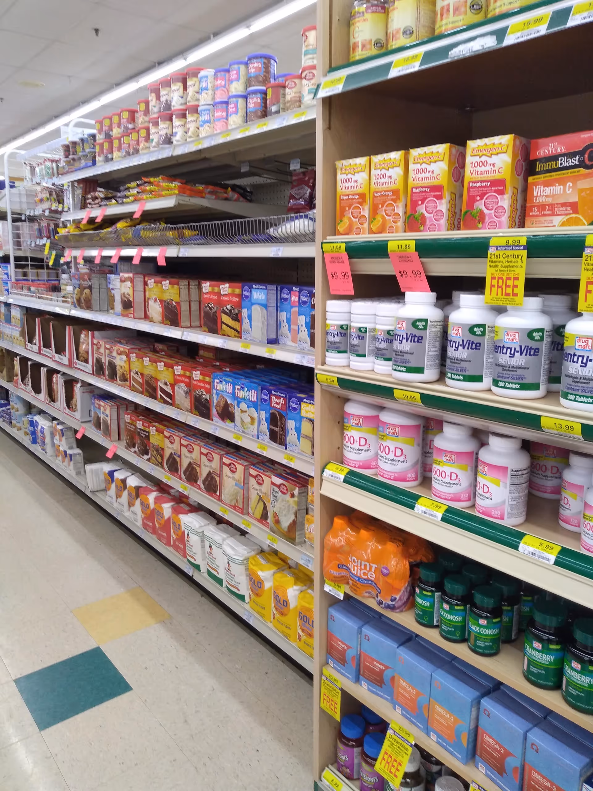Interior of Discount Drug Mart pharmacy aisle filled with vitamins and health supplements
