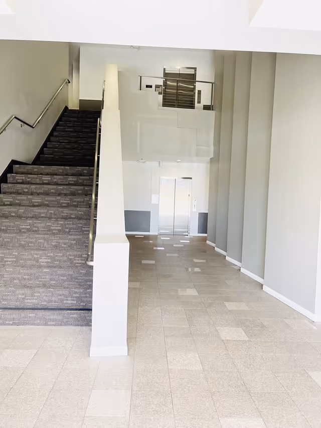 BrightStar Care facility lobby interior with stairs and an elevator.