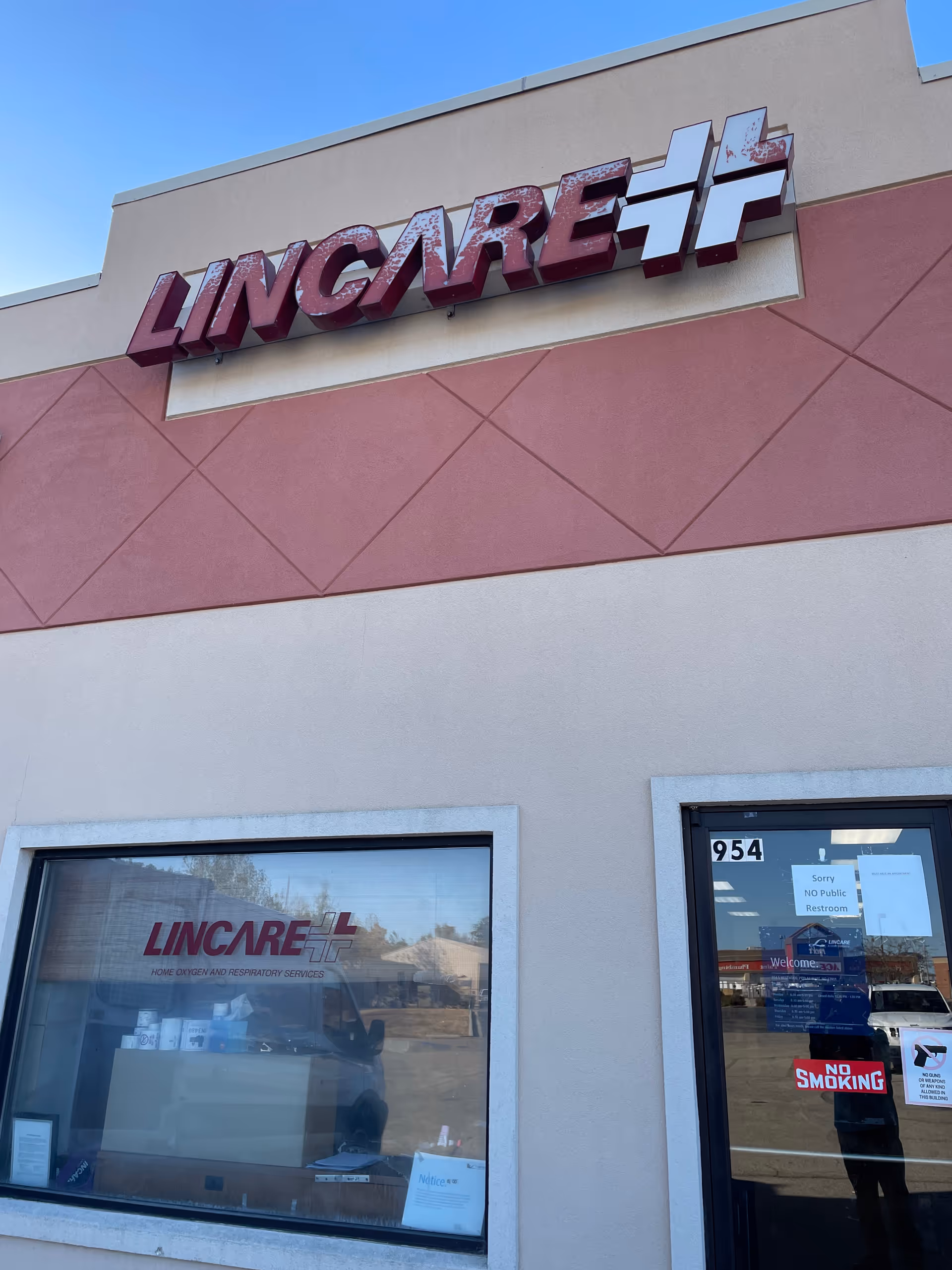 Exterior view of a LINCARE building with a large sign on the facade.