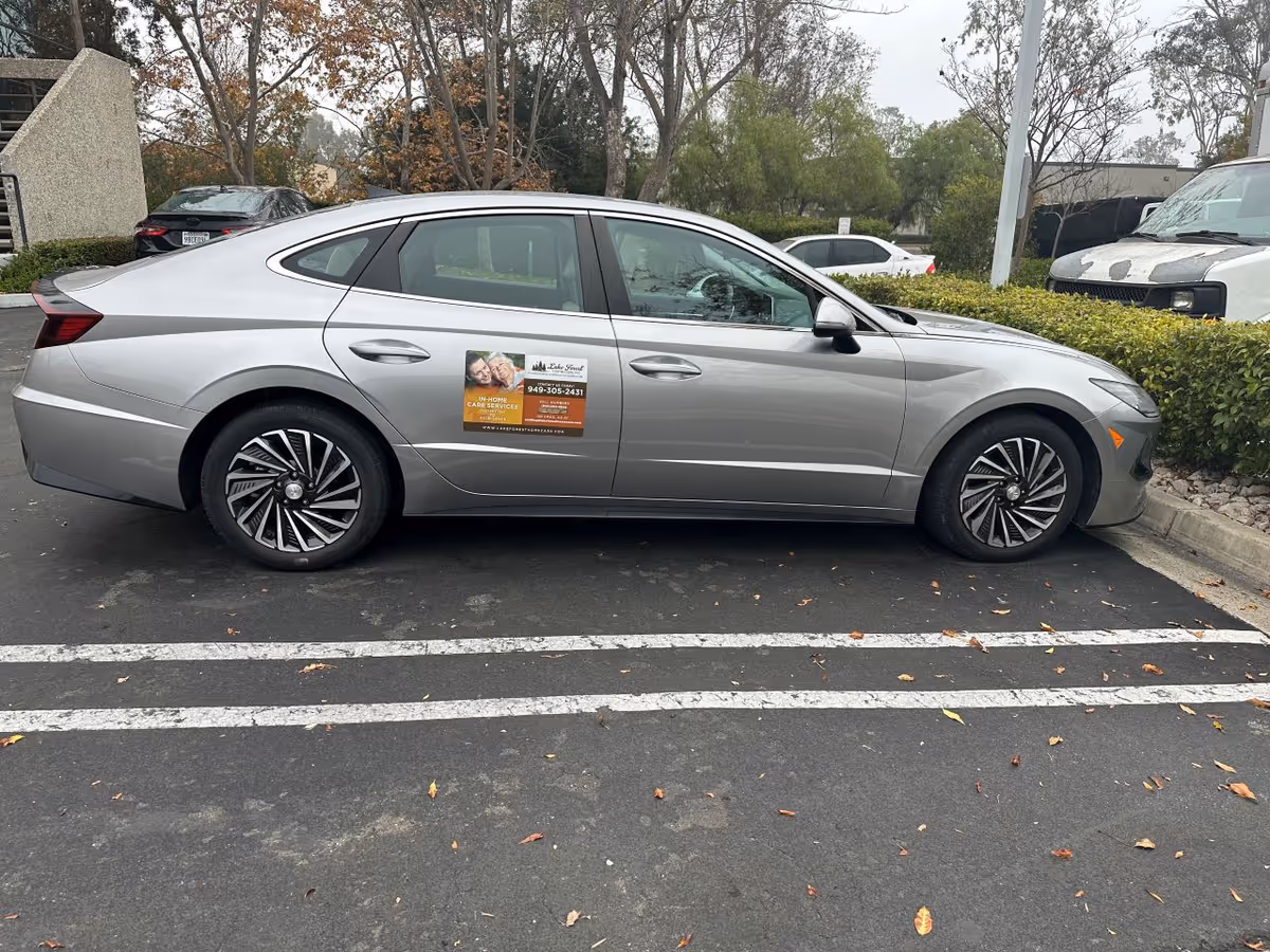 Silver sedan with a Lake Forest Home Care sticker parked in a parking lot.