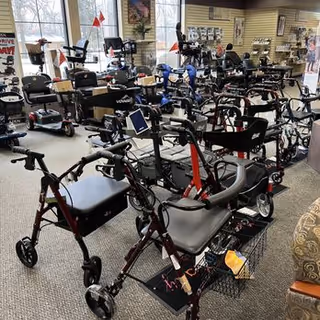 Interior showroom filled with mobility devices such as walkers, wheelchairs, and scooters.